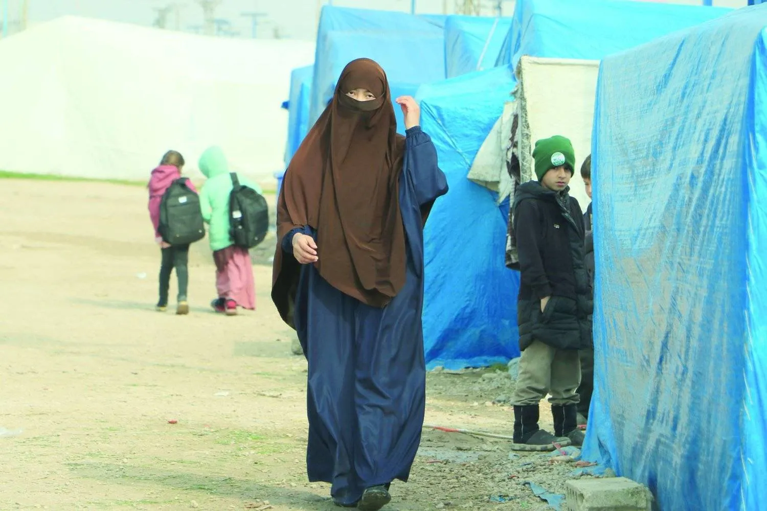 Women and children of ISIS militants walk in Syria’s Roj camp in northeastern Syria (Asharq Al-Awsat)