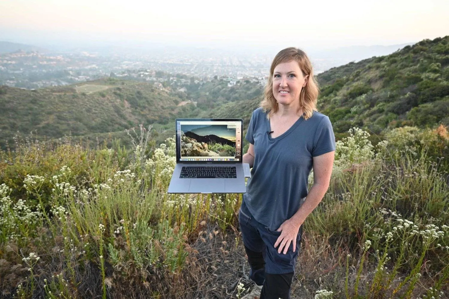 Wildlife photographer Johanna Turner shows her "camera trap" photo of a cougar as she poses for a photo in the hills above Glendale, California, on May 30, 2024. (Photo by Robyn Beck / AFP)