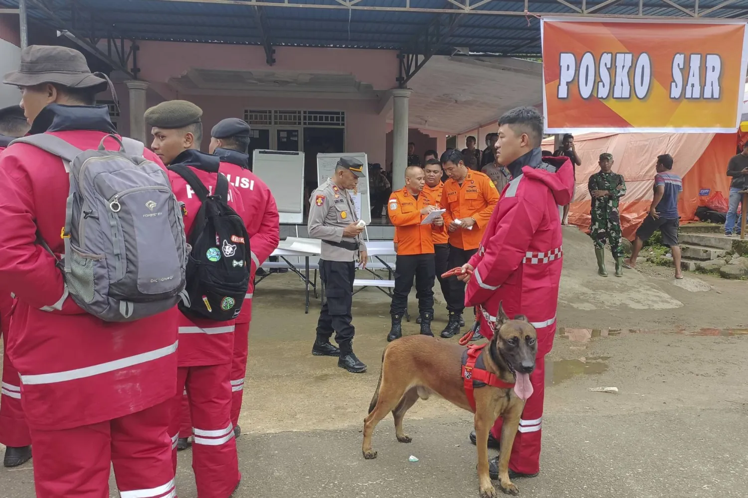 In this photo released by the Indonesian National Search and Rescue Agency (BASARNAS), rescuers prepare to head out to the site of a landslide in Suwawa on Sulawesi Island, Indonesia, Monday, July 8, 2024. (BASARNAS via AP)
