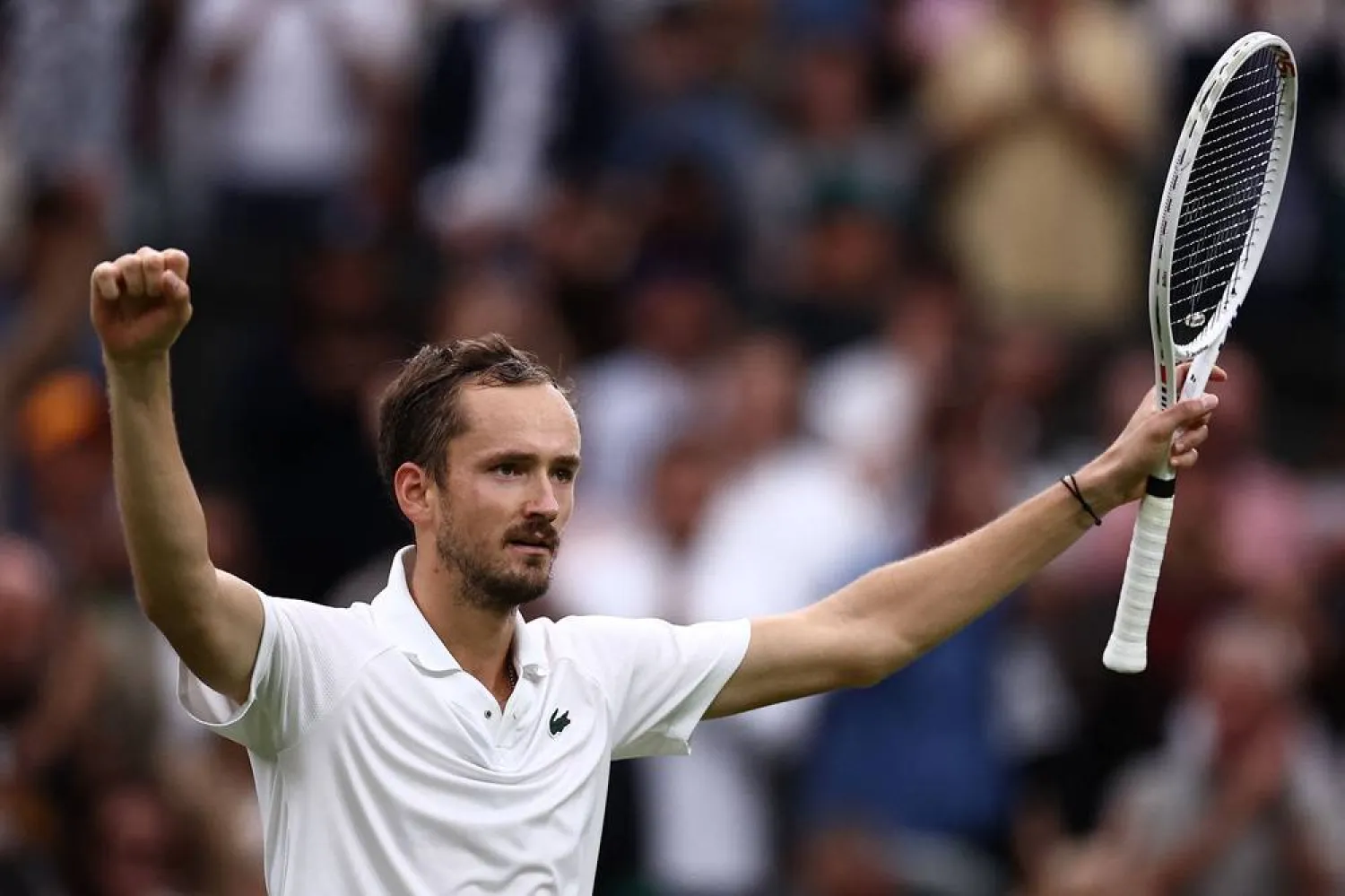 Russia's Daniil Medvedev celebrates winning against Italy's Jannik Sinner during their men's singles quarter-final tennis match on the ninth day of the 2024 Wimbledon Championships at The All England Lawn Tennis and Croquet Club in Wimbledon, southwest London, on July 9, 2024. (AFP)