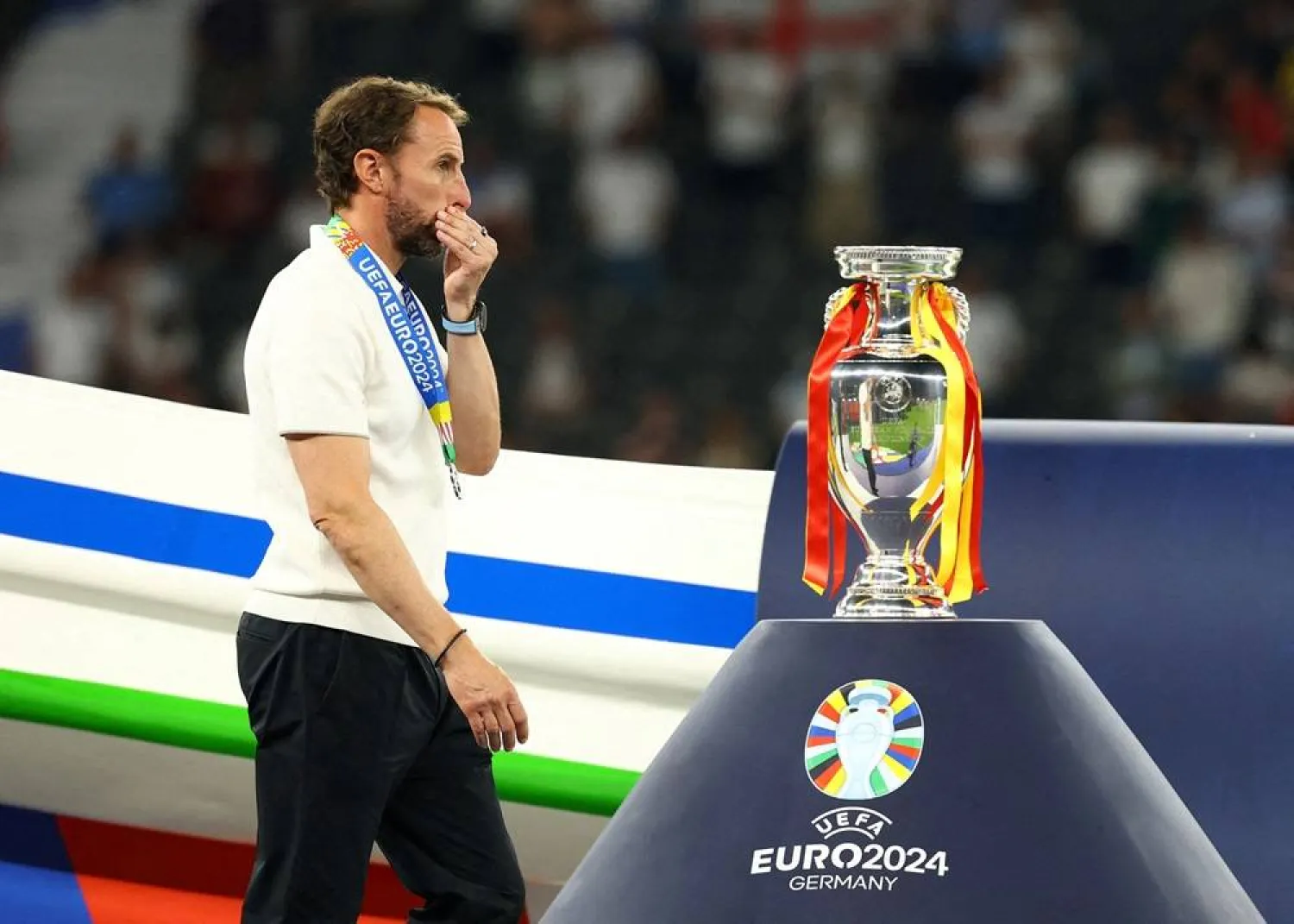  Soccer Football - Euro 2024 - Final - Spain v England - Berlin Olympiastadion, Berlin, Germany - July 14, 2024 England manager Gareth Southgate looks dejected as he walks past the trophy after receiving his runners up medal. (Reuters)