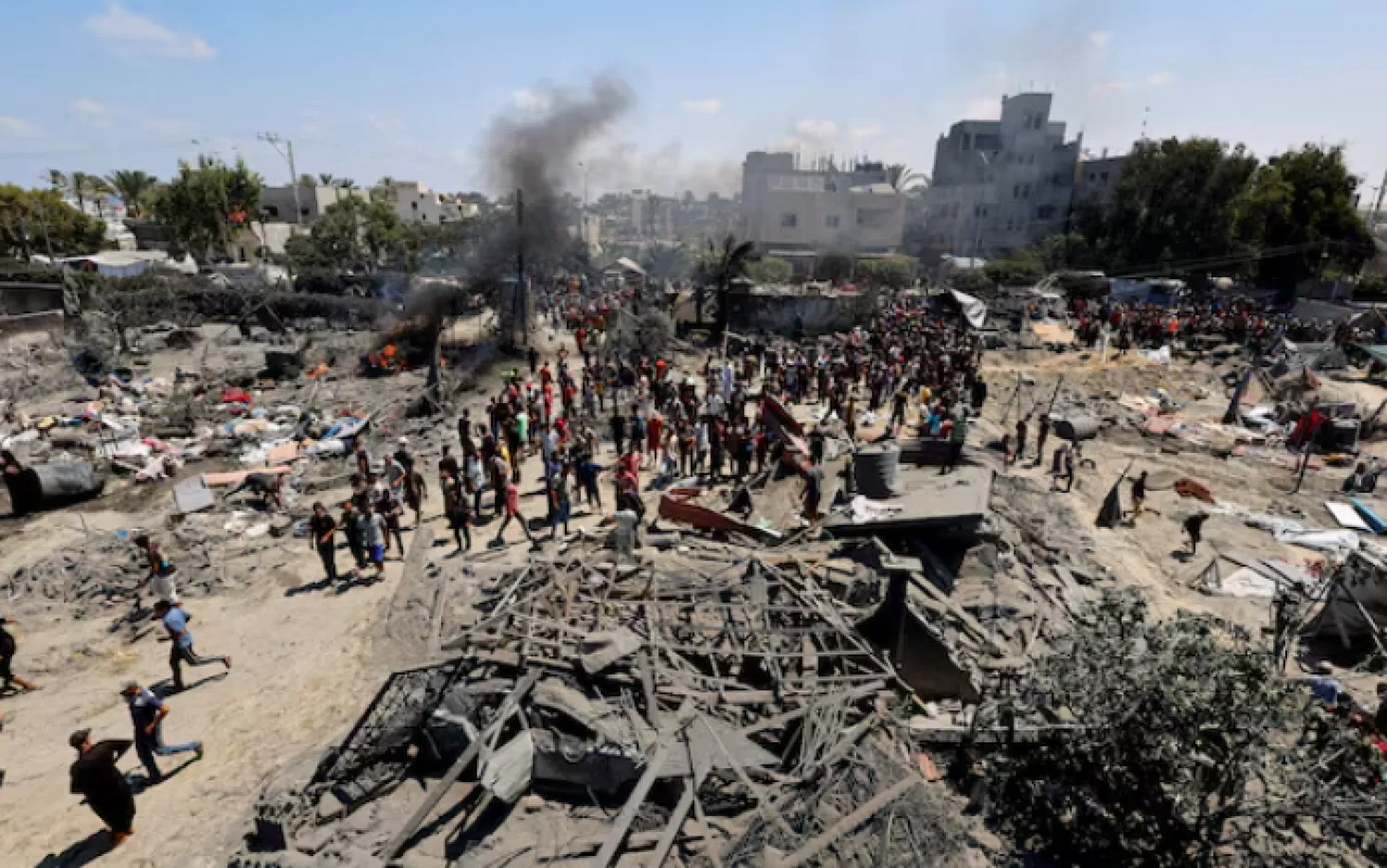 Palestinians gather near damage, following what Palestinians say was an Israeli strike at a tent camp in Al-Mawasi area, amid Israel-Hamas conflict, in Khan Younis in the southern Gaza Strip July 13, 2024. REUTERS/Mohammed Salem/File Photo Purchase Licensing Rights