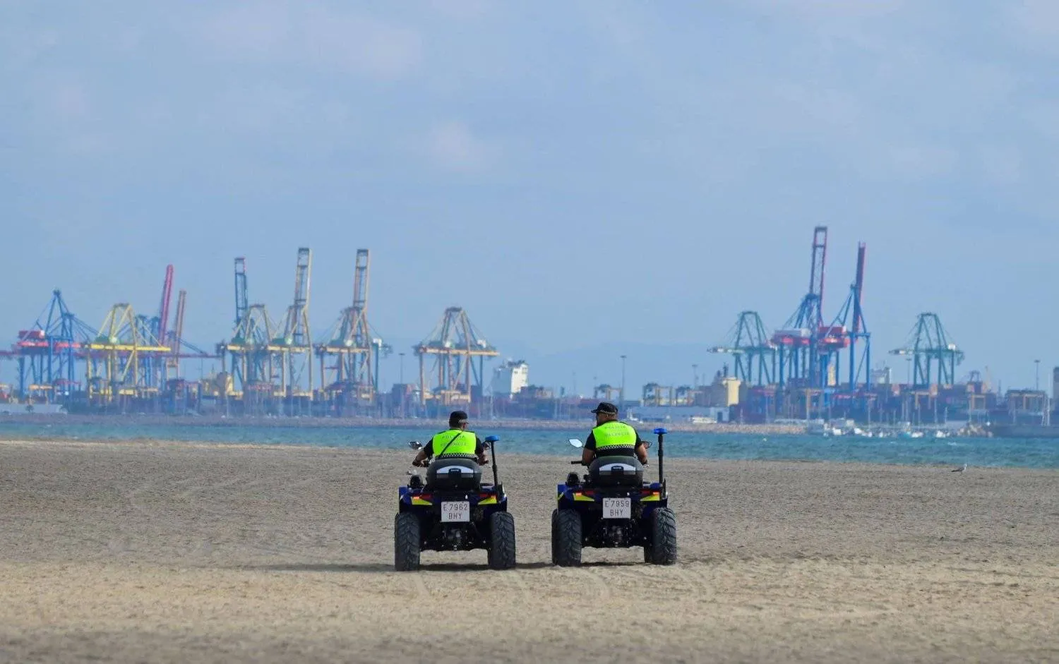Municipal police officers patrol the El Saler beach in the Albufera Natural Park, after the city council of Valencia closed three beaches on the Mediterranean coast following a suspected oil or fuel spill on the sand, in Valencia, Spain on July 17, 2024 (Photo by Jose Jordan / AFP)