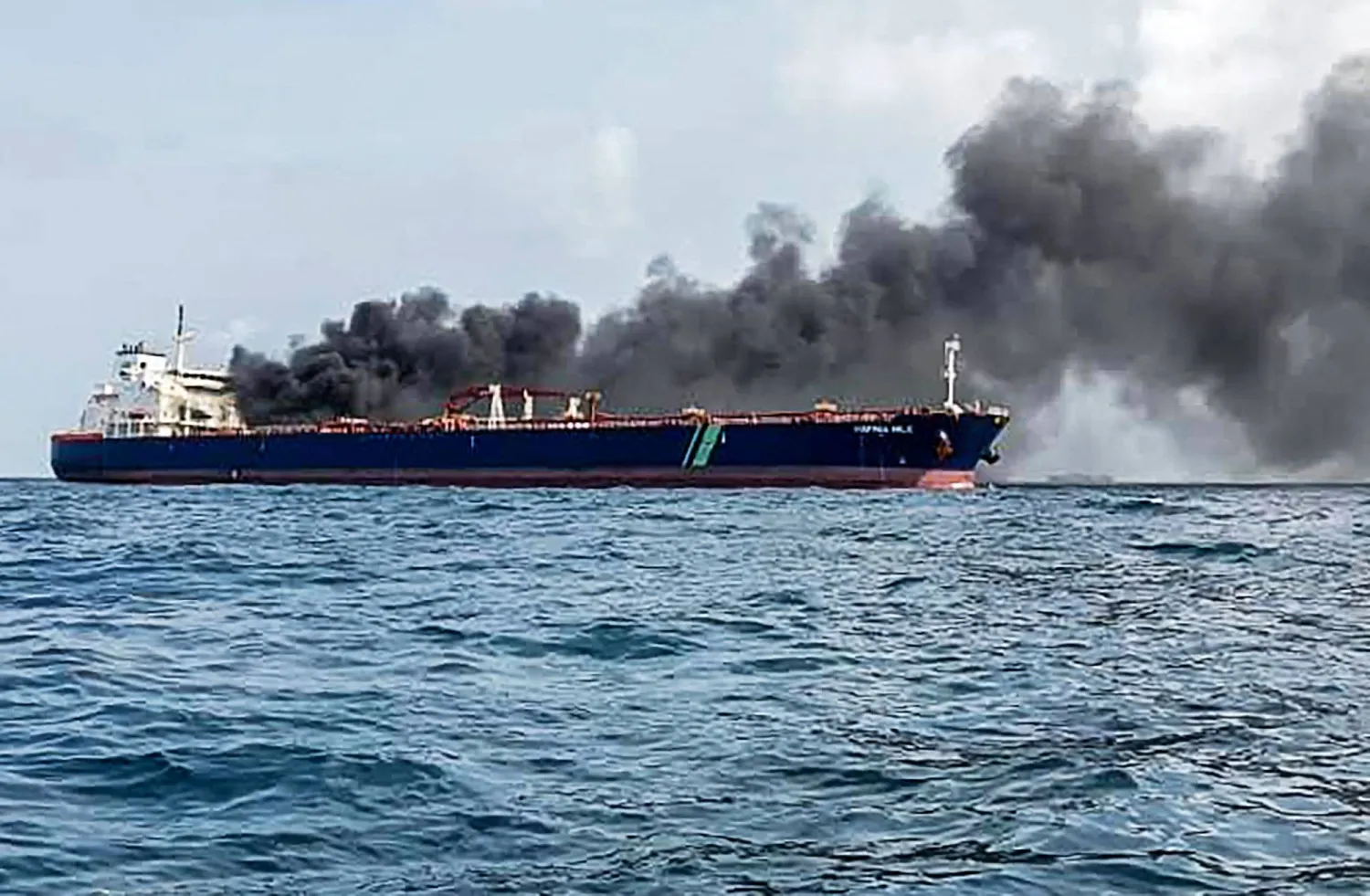 A handout photo taken and released by Malaysian Maritime Enforcement Agency on July 19, 2024 shows the Singapore-flagged tanker Hafnia Nile on fire in Tanjung Sedili, near Singapore. (Photo by Handout / Malaysian Maritime Enforcement A / AFP)
