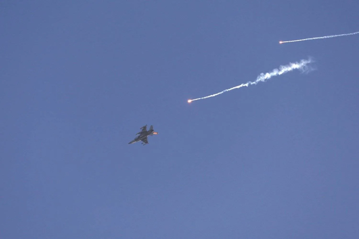 An Israeli fighter jet ejects flares while flying over an area near the Lebanon-Israel border, as seen from an undisclosed location in northern Israel, 07 July 2024. EPA/ATEF SAFADI

