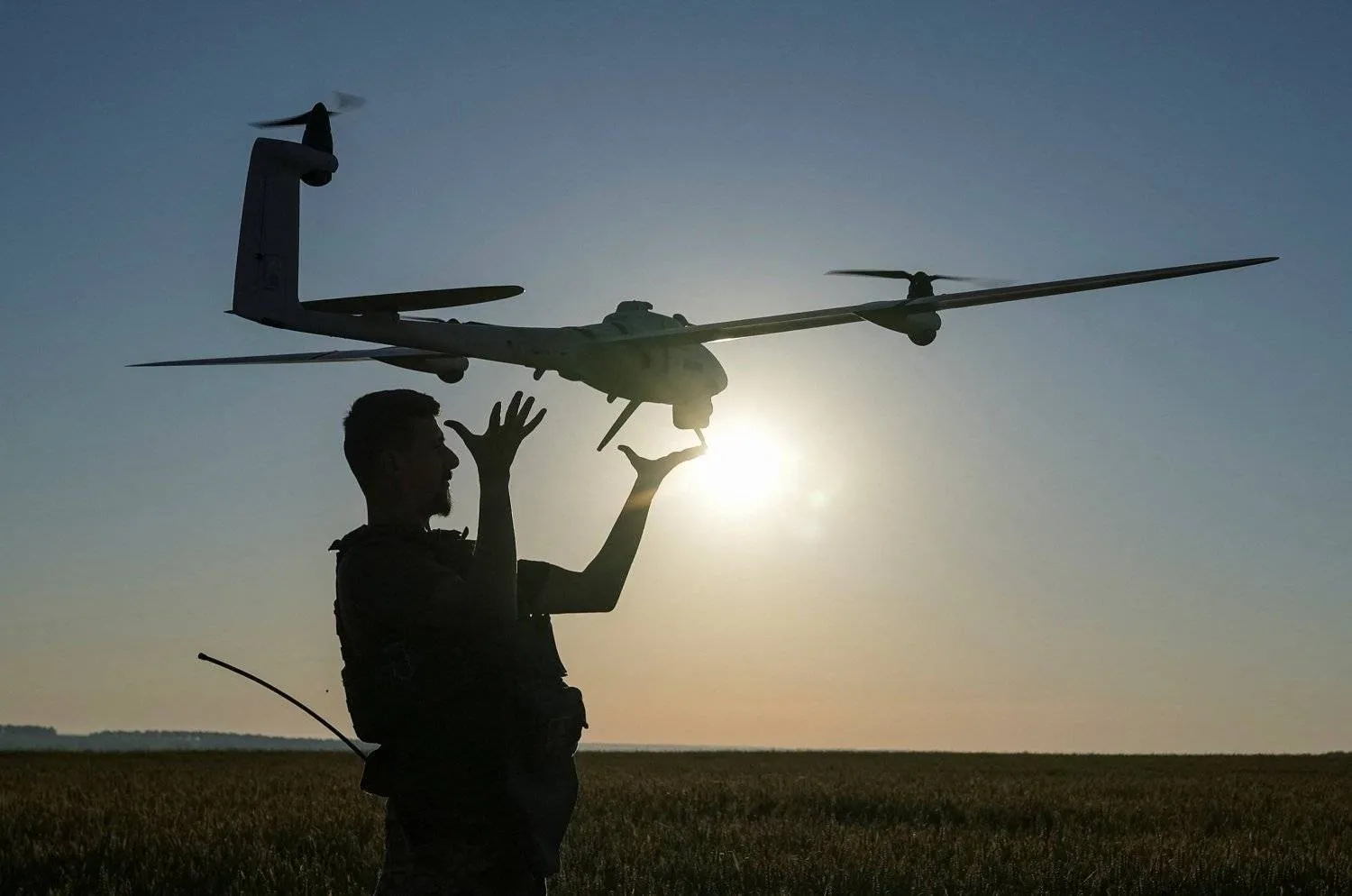 A Ukrainian serviceman belonging to the attack drones battalion of the Achilles, 92nd brigade, launches a mid-range reconnaissance type drone, Vector, for flying over positions of Russian troops, amid Russia's attack on Ukraine, in a Kharkiv region, Ukraine June 19, 2024. REUTERS/Inna Varenytsia
