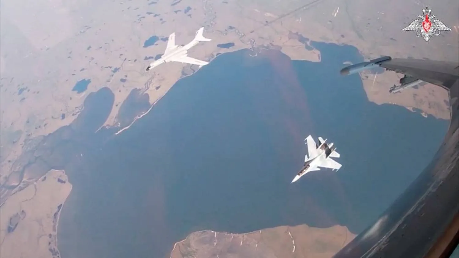 A H-6K bomber of the Chinese People's Liberation Army (PLA) Air Force is accompanied by a Russian Sukhoi Su-30CM jet fighter during joint Russian and Chinese military plane patrols near the US state of Alaska, in this still image from video released July 25, 2024. (Russian Defense Ministry/Handout via Reuters) 
