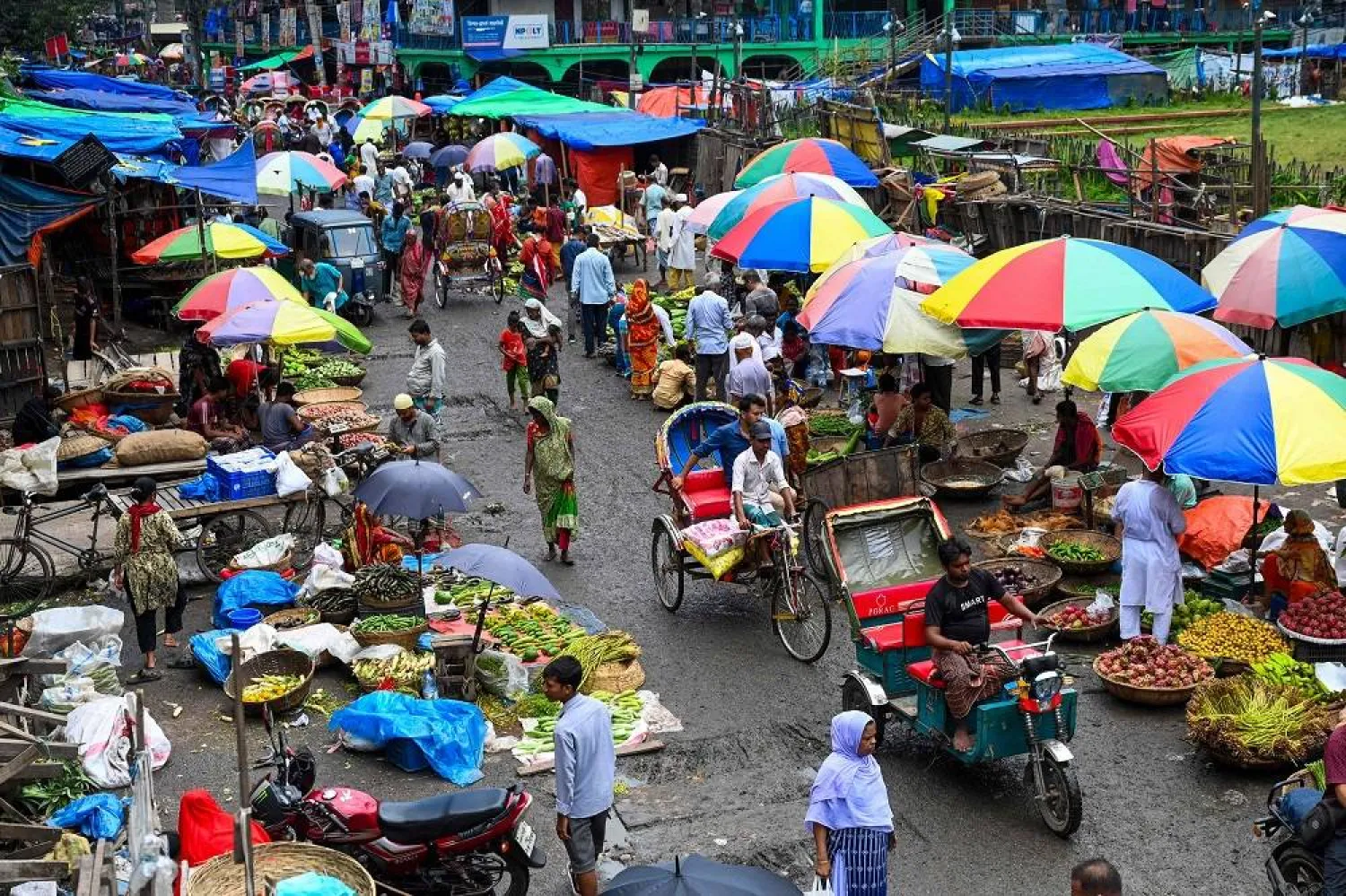 People shop at a market as the curfew is relaxed after the anti-quota protests, in Dhaka on July 25, 2024. (AFP)