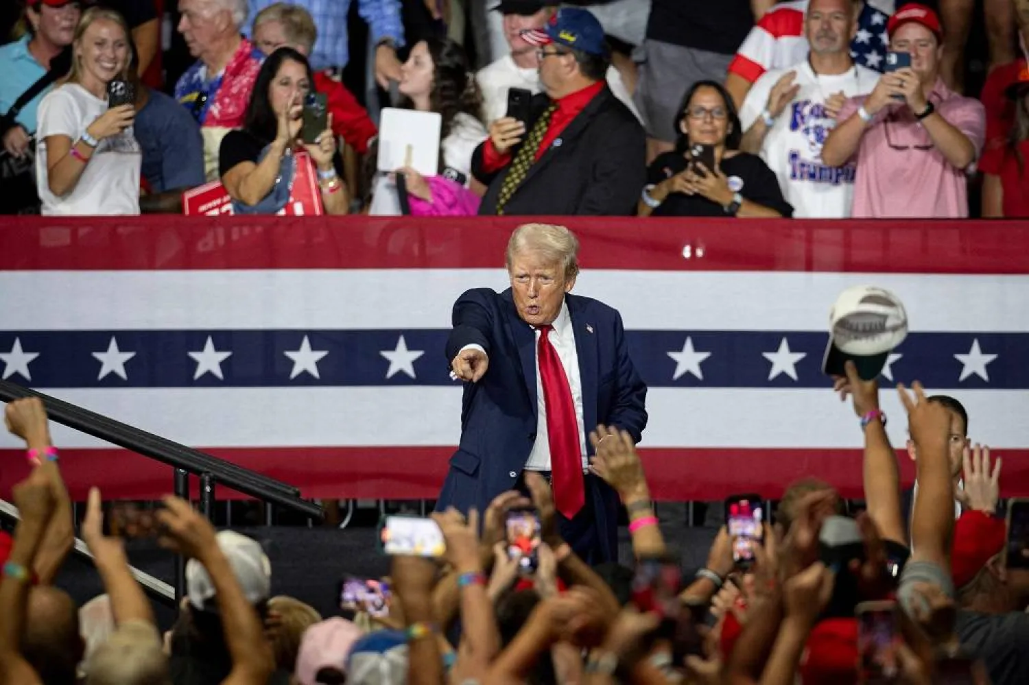Former US President and 2024 Republican presidential candidate Donald Trump points to supporters in the crowd after speaking during a campaign rally at the Bojangles Coliseum in Charlotte, North Carolina, on July 24, 2024. (AFP)
