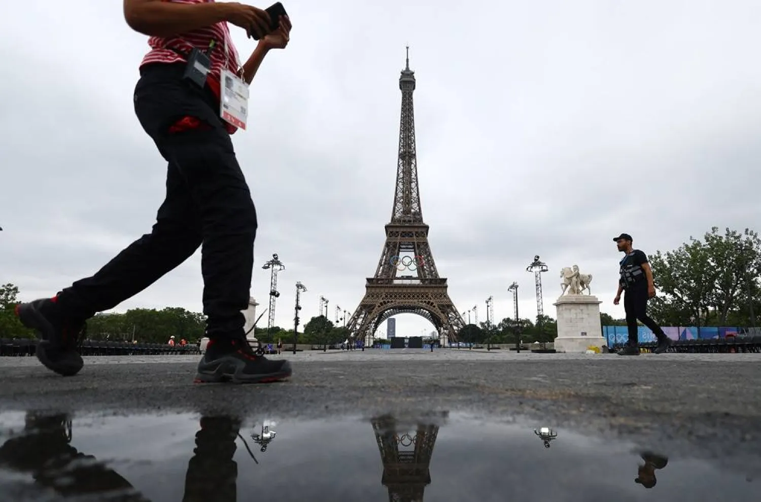 Paris 2024 Olympics - Opening Ceremony - Paris, France - July 26, 2024. Spectators are seen behind the Eiffel Tower ahead of the opening ceremony of the Paris 2024 Olympics. (Reuters) 
