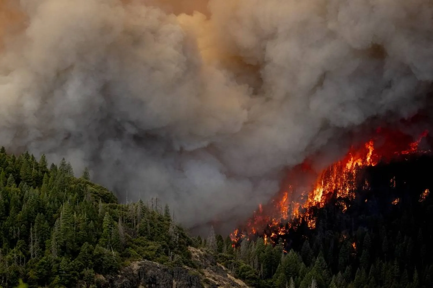  A column of flame burns on a hillside during the Park Fire near Lomo, Calif., Friday, July 26, 2024. (Stephen Lam/San Francisco Chronicle via AP) 