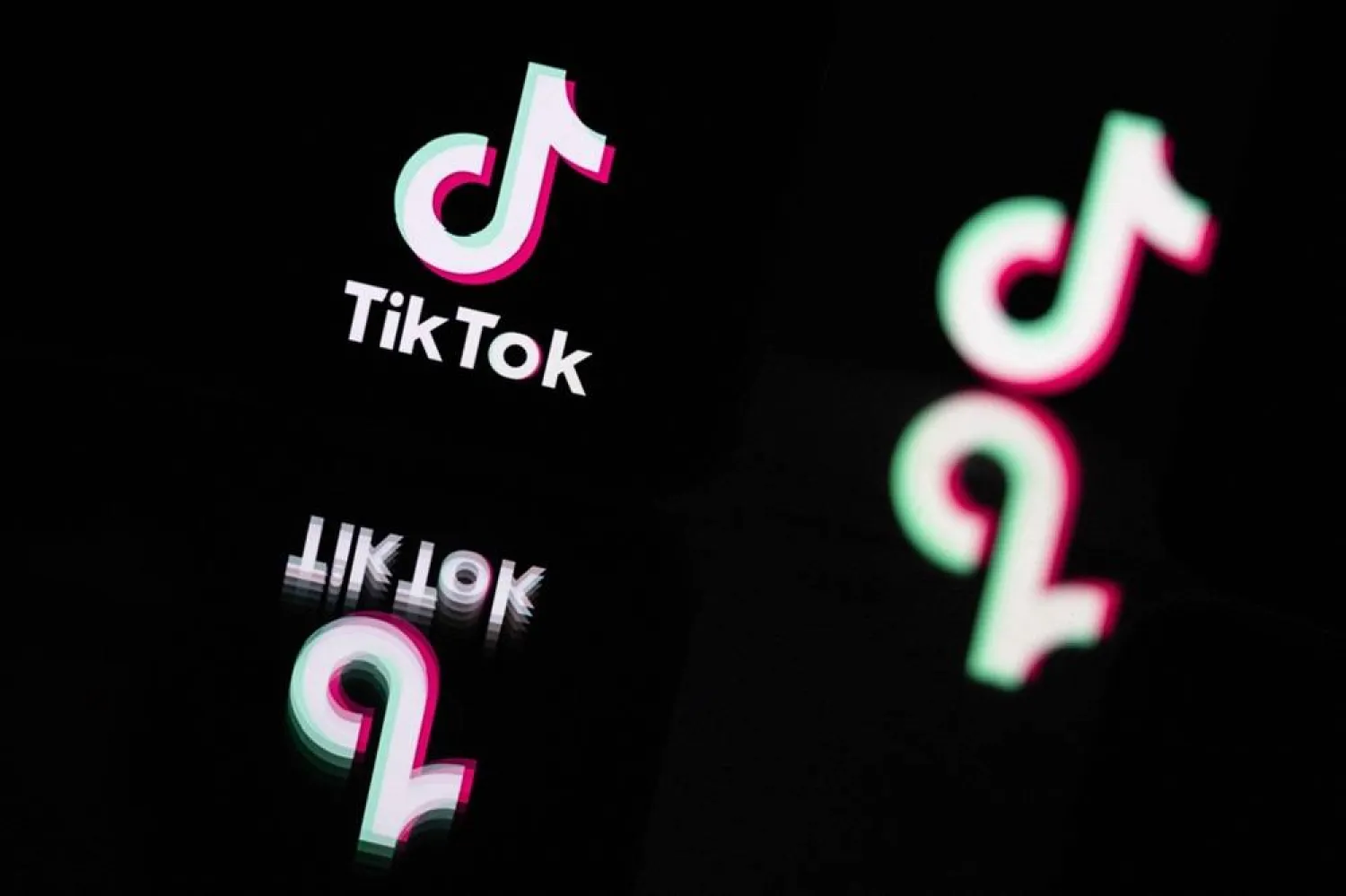 This photograph taken in Mulhouse, eastern France on October 19, 2023, shows the logo of the social media video sharing app TikTok reflected in mirrors. (AFP)