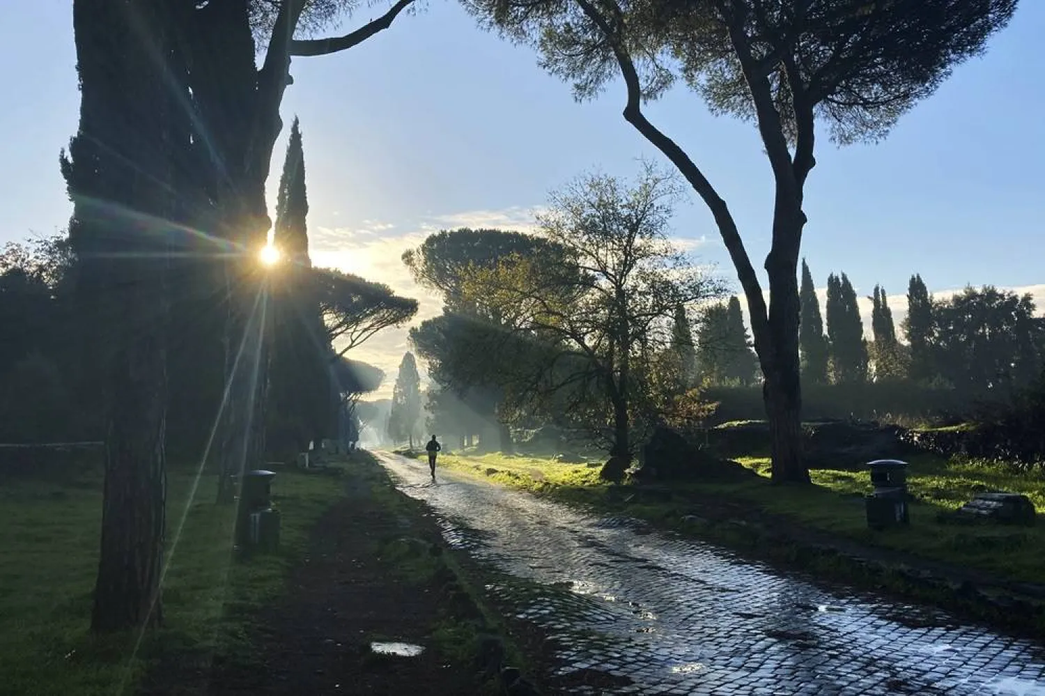 A man jogs on the ancient roman Appian Way in Rome, Friday, Dec. 11, 2020. (AP)