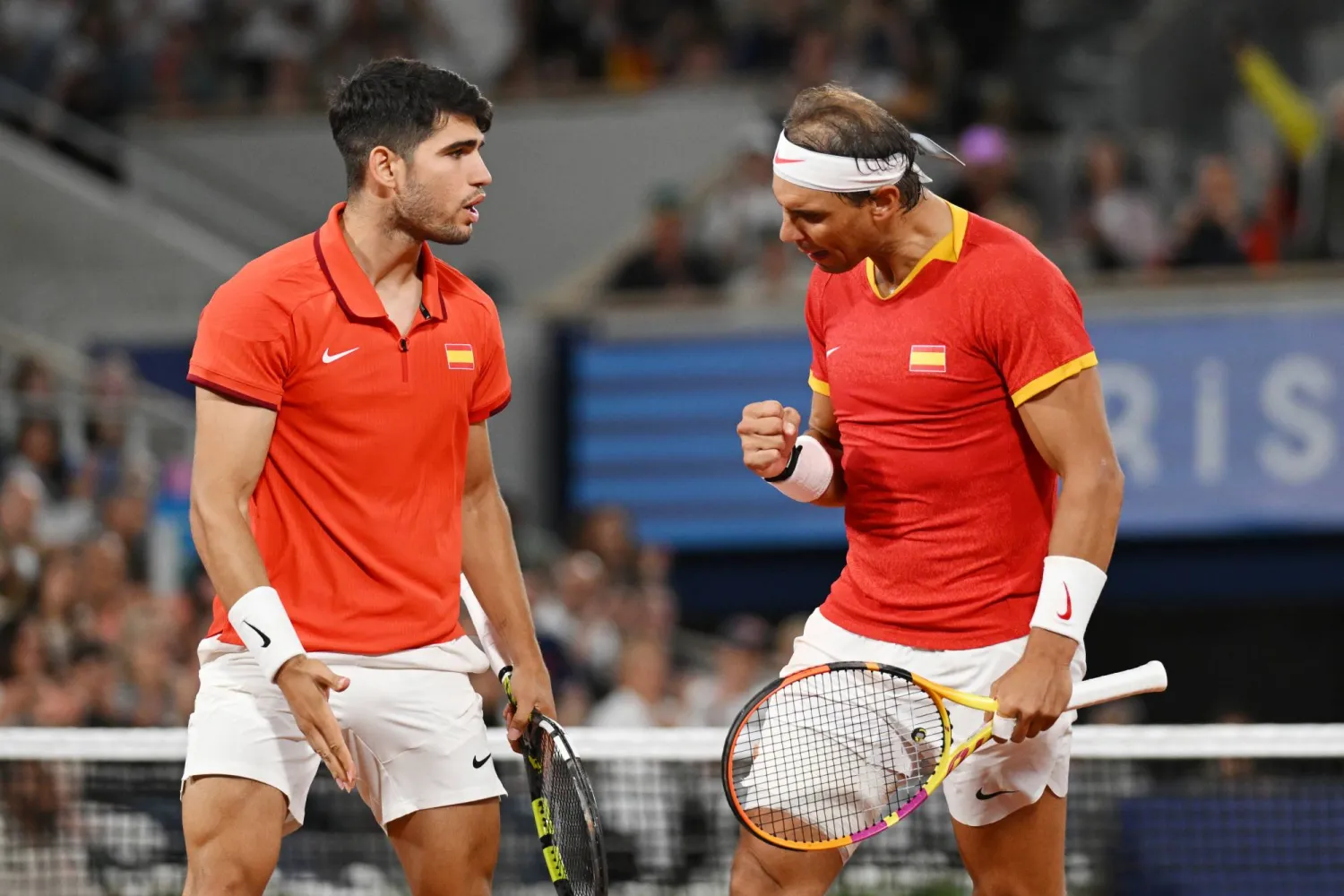 27 July 2024, France, Paris: Spanish tennis players Rafael Nadal (R) and Carlos Alcaraz celebrate after winning their men's doubles 1st round tennis match against Argentina's Maximo Gonzalez and Andres Molteni at Roland-Garros on the first day of the 2024 Paris Olympic Games in France. Photo: Marijan Murat/dpa