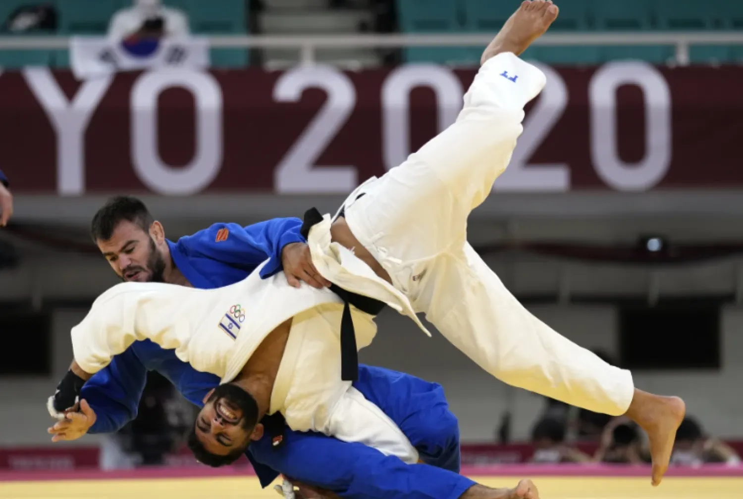 FILE - Victor Sterpu of Moldova, background and Tohar Butbul of Israel compete during their men’s -73kg round of 16 judo match at the 2020 Summer Olympics in Tokyo, Japan, Monday, July 26, 2021. (AP Photo/Vincent Thian, FIle)