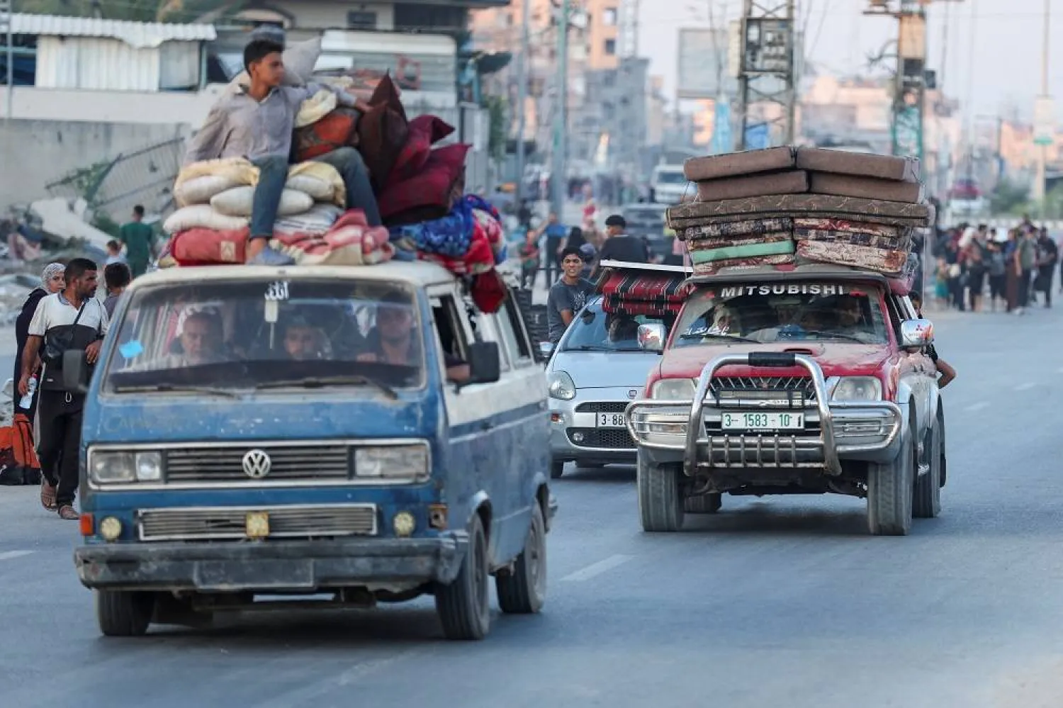 Palestinians travel in vehicles as they flee Bureij after they were ordered by Israeli army to evacuate the area, amid Israel-Hamas conflict, in the central Gaza Strip July 28, 2024. (Reuters)
