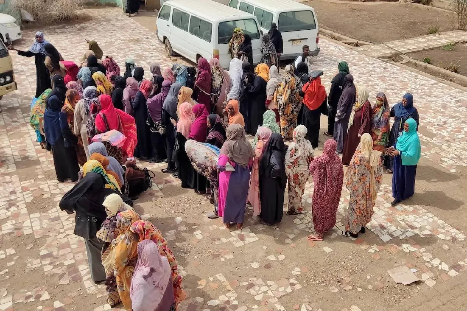 Internally displaced Sudanese women wait in a queue to collect aid from a group at a camp in the eastern state of Gedaref on May 19, 2024. (AFP) 