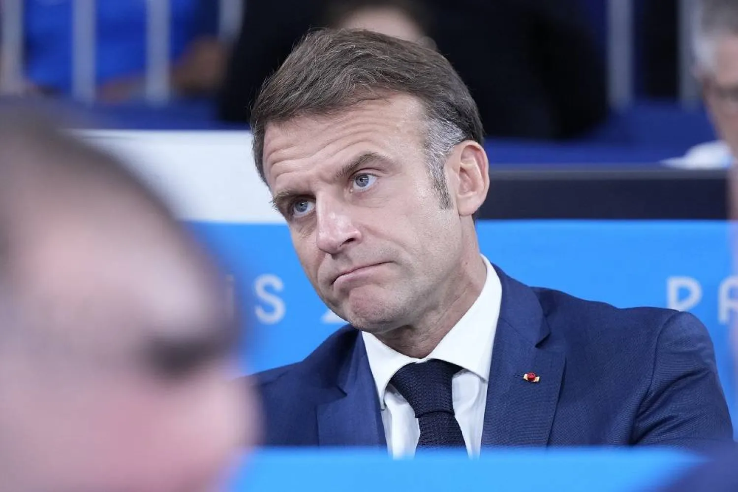 French President Emmanuel Macron watches a match during a women -48 kg bronze final in team judo competition at Champ-de-Mars Arena during the 2024 Summer Olympics, Saturday, July 27, 2024, in Paris, France. (AP)