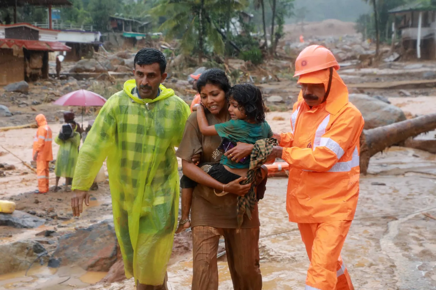 Rescuers help residents to move to a safer place, at a landslide site after multiple landslides in the hills, in Wayanad, in the southern state of Kerala, India, July 30, 2024. REUTERS/Stringer