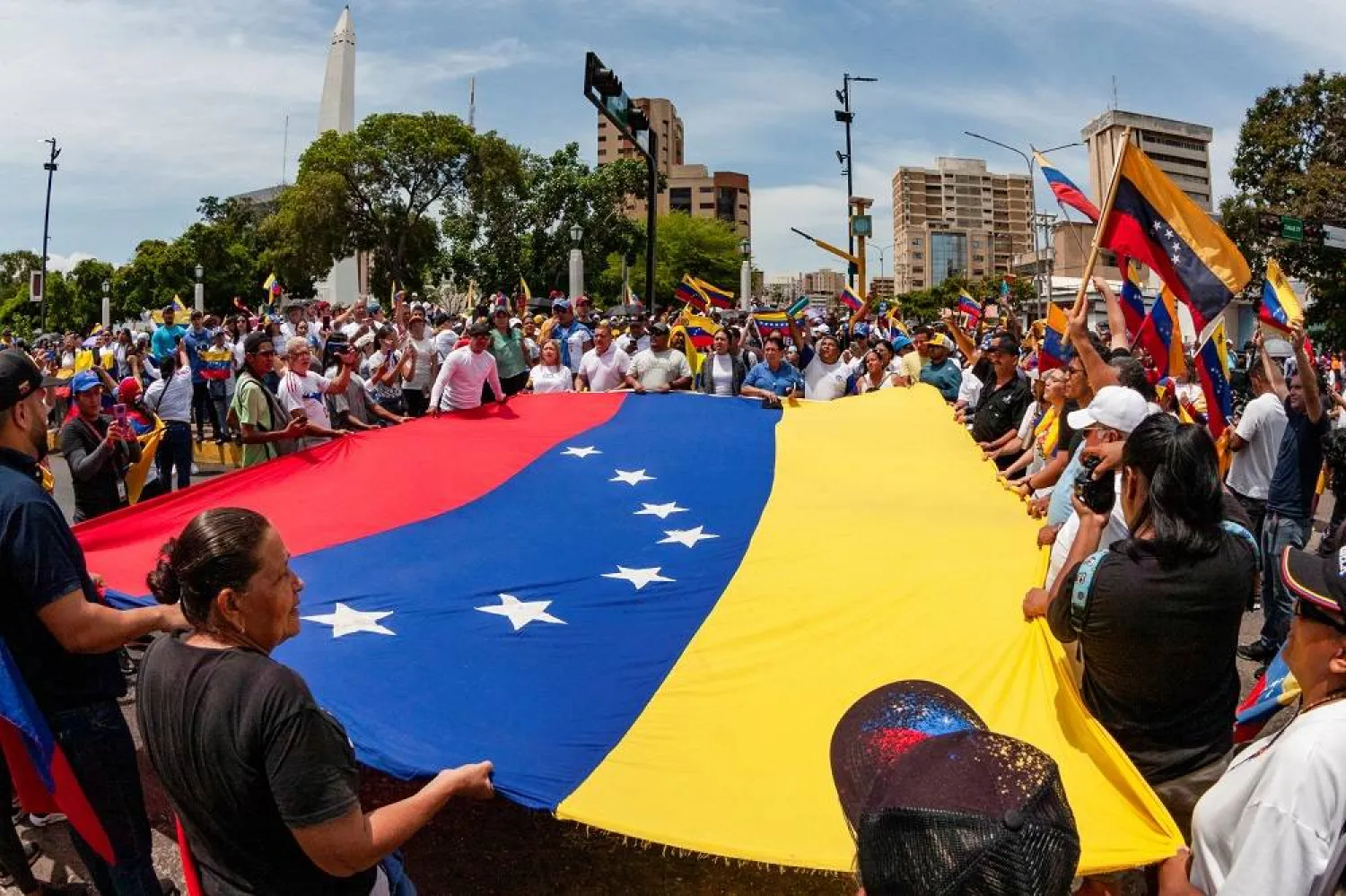 People carry Venezuela's national flag to protest the election results that awarded Venezuela's President Nicolas Maduro with a third term, in Maracaibo, Venezuela July 30, 2024. (Reuters)