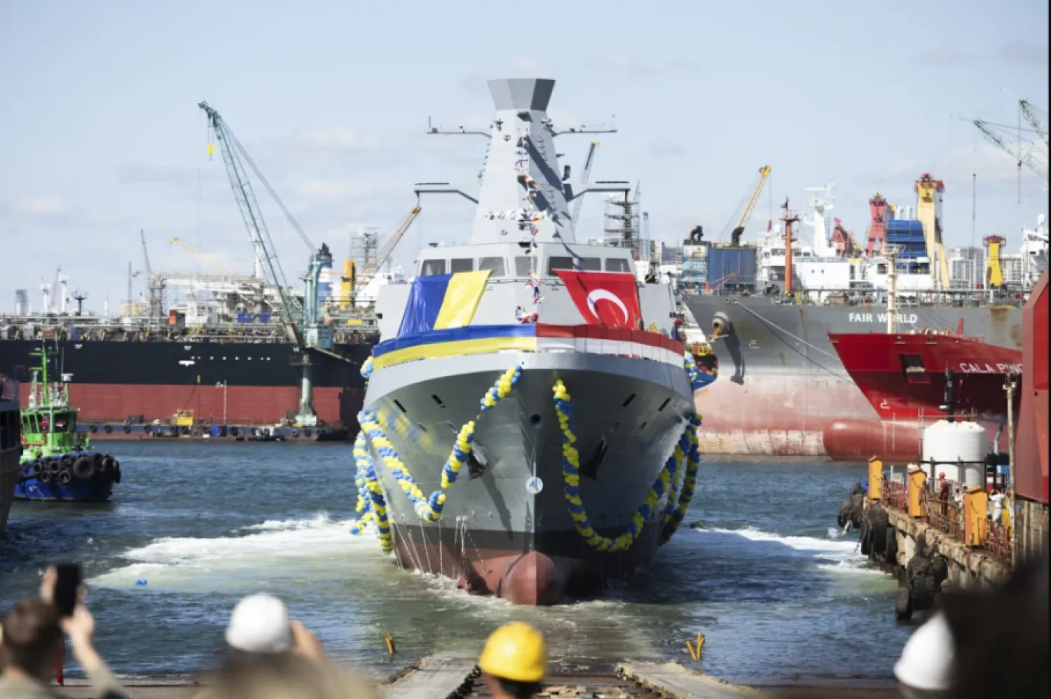 In this photo provided by the Ukrainian Presidential Press Office, people react during the launching ceremony of the Ukrainian Navy’s Ada class corvette “Hetman Ivan Vyhovskyi” in Istanbul, Türkiye, Thursday, Aug. 1, 2024. This vessel was constructed for the Ukrainian Navy at a shipyard in Türkiye. (Ukrainian Presidential Press Office via AP)

