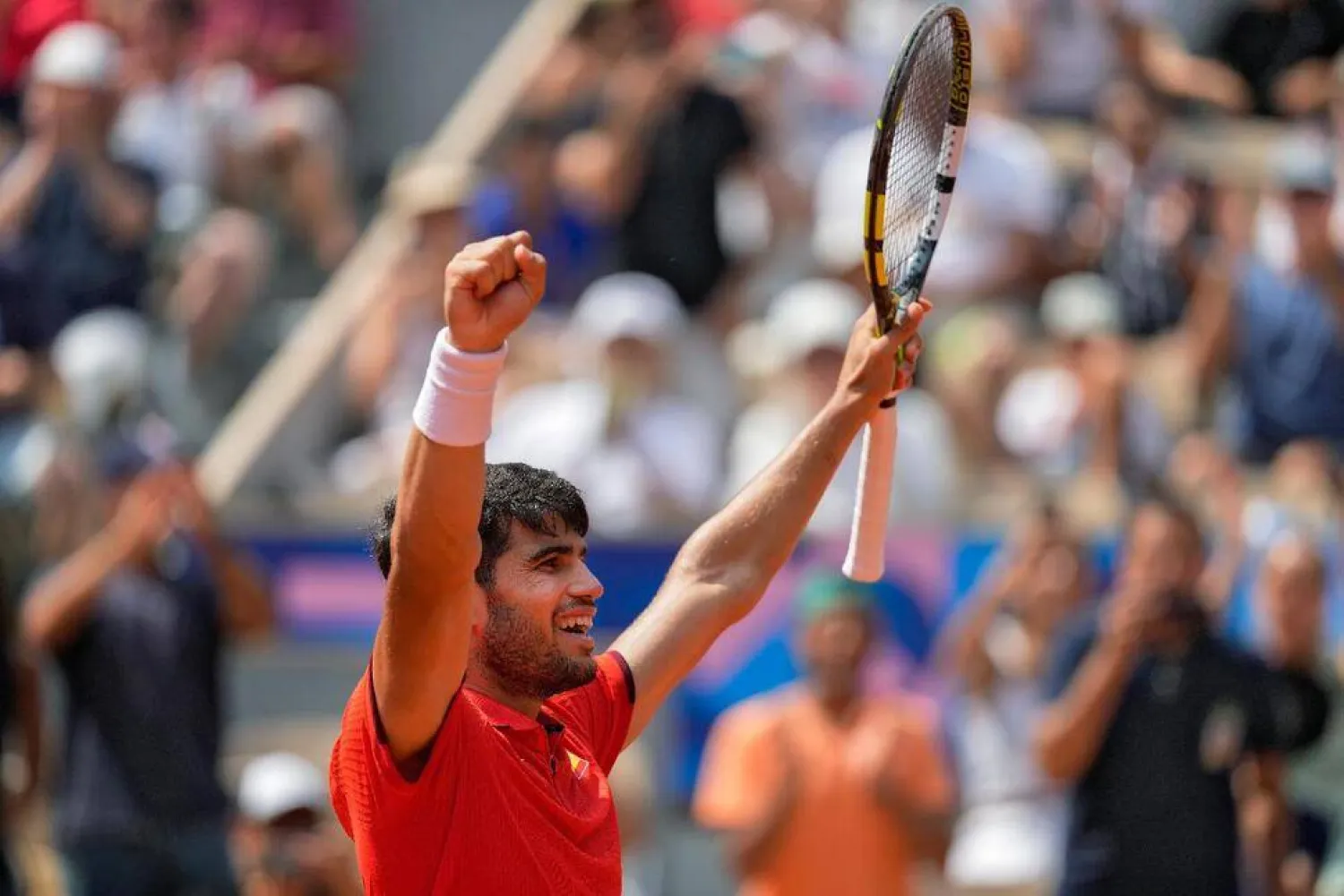 Carlos Alcaraz of Spain celebrates after defeating Felix Auger-Aliassime of Canada in their men's singles semifinals tennis match, at the 2024 Summer Olympics, Friday, Aug. 2, 2024, at the Roland Garros stadium in Paris, France. (AP Photo/Andy Wong)

