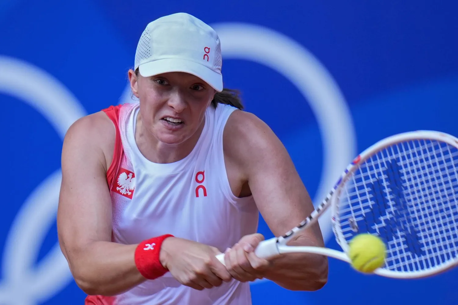 Iga Swiatek of Poland returns a shot to Anna Karolina Schmiedlova of Slovakia during their women's bronze medal match, at the 2024 Summer Olympics, Friday, Aug. 2, 2024, at the Roland Garros stadium in Paris, France. (AP Photo/Andy Wong)