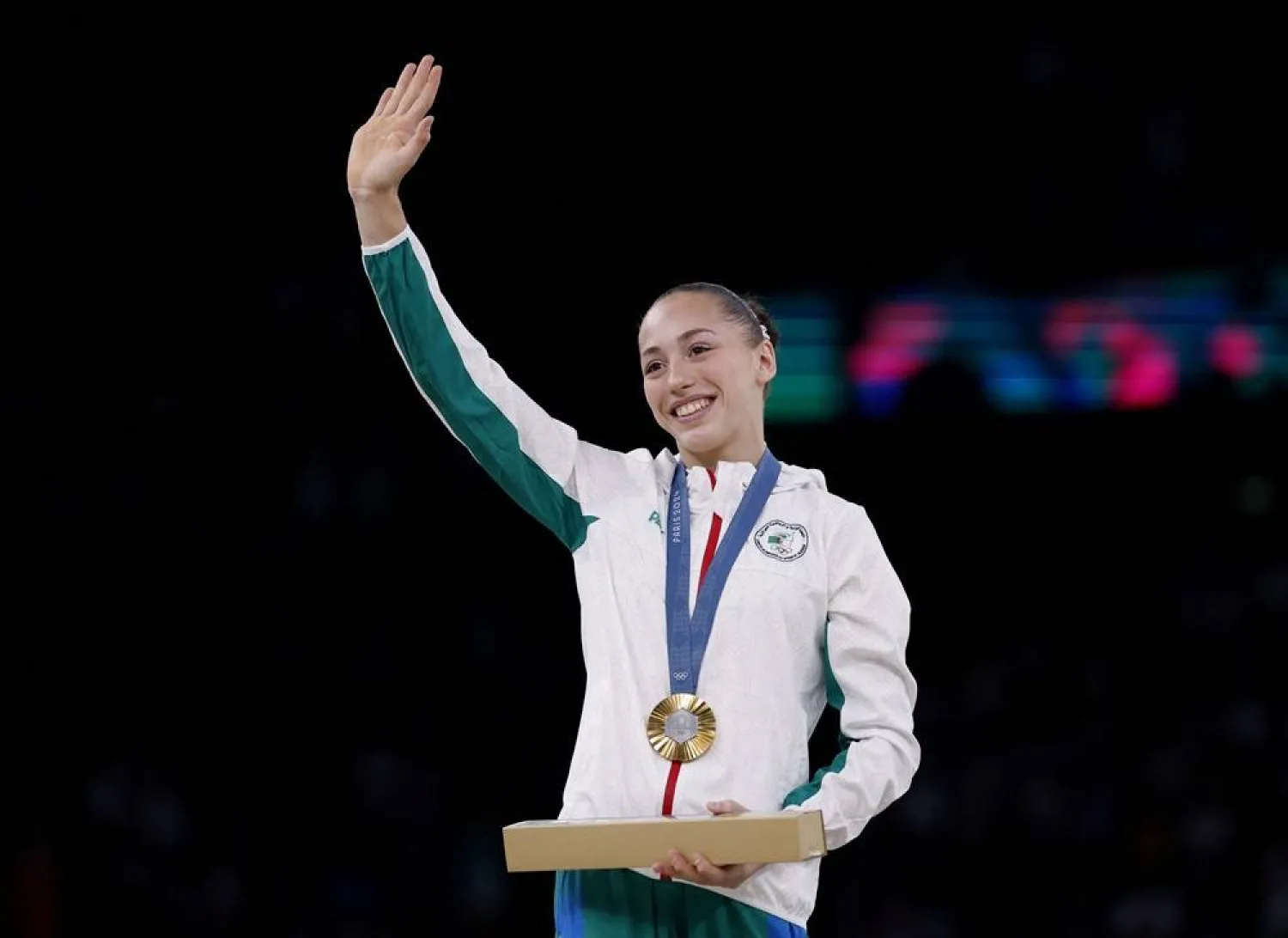  Paris 2024 Olympics - Artistic Gymnastics - Women's Uneven Bars Victory Ceremony - Bercy Arena, Paris, France - August 04, 2024. Gold medalist Kaylia Nemour of Algeria celebrates with her medal on the podium. (Reuters)