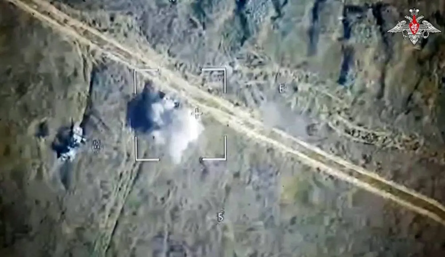 An image taken from a handout footage released by the Russian Defense Ministry on August 6, 2024, shows Russian drone attack on Ukrainian armored vehicles outside the town of Sudzha, Kursk Region, on August 7, 2024. (Russian Defense Ministry / AFP) 