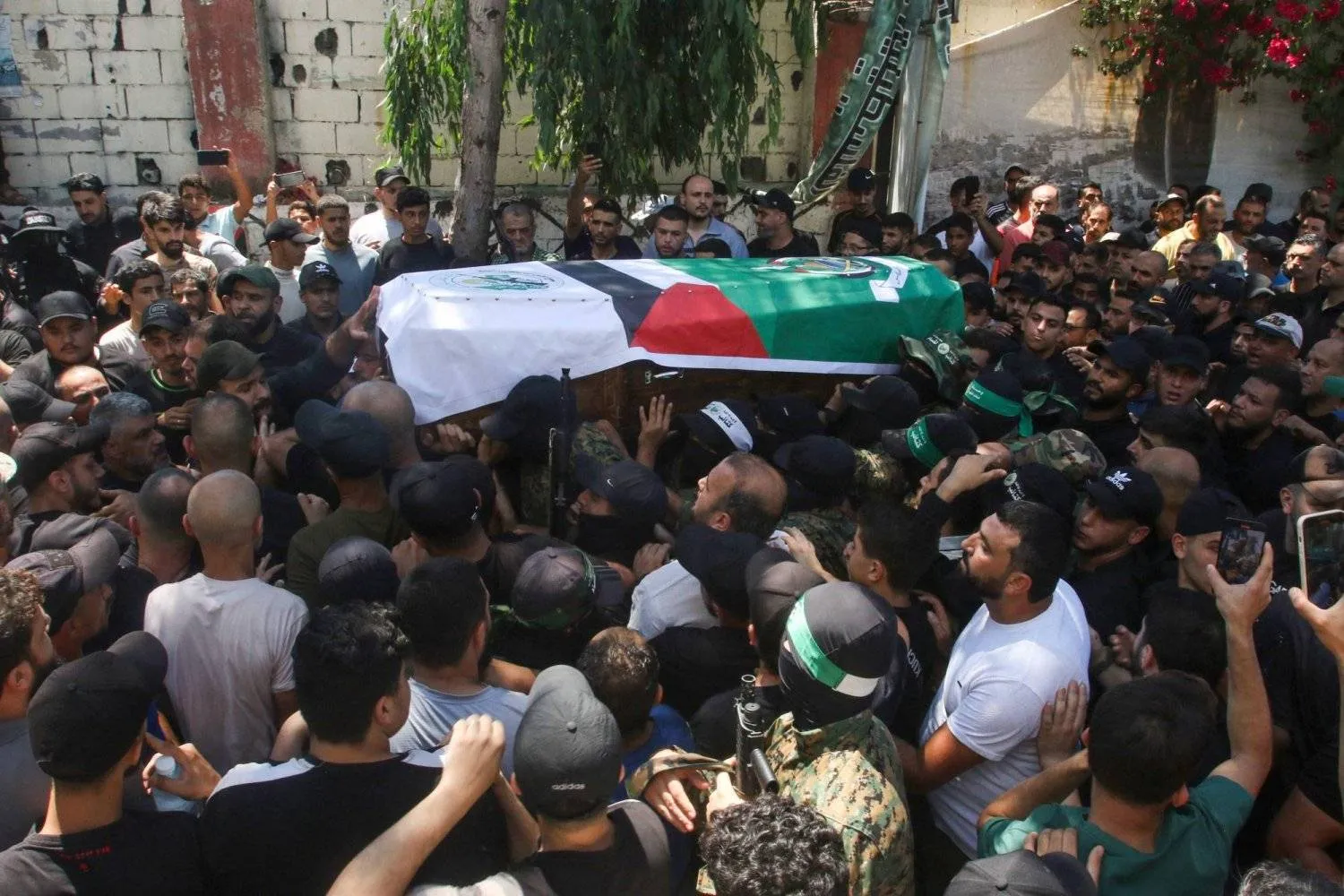 Members of Hamas' Ezzedin al-Qassam Brigades mourn a commander assassinated by Israel in Sidon on Friday (AFP)