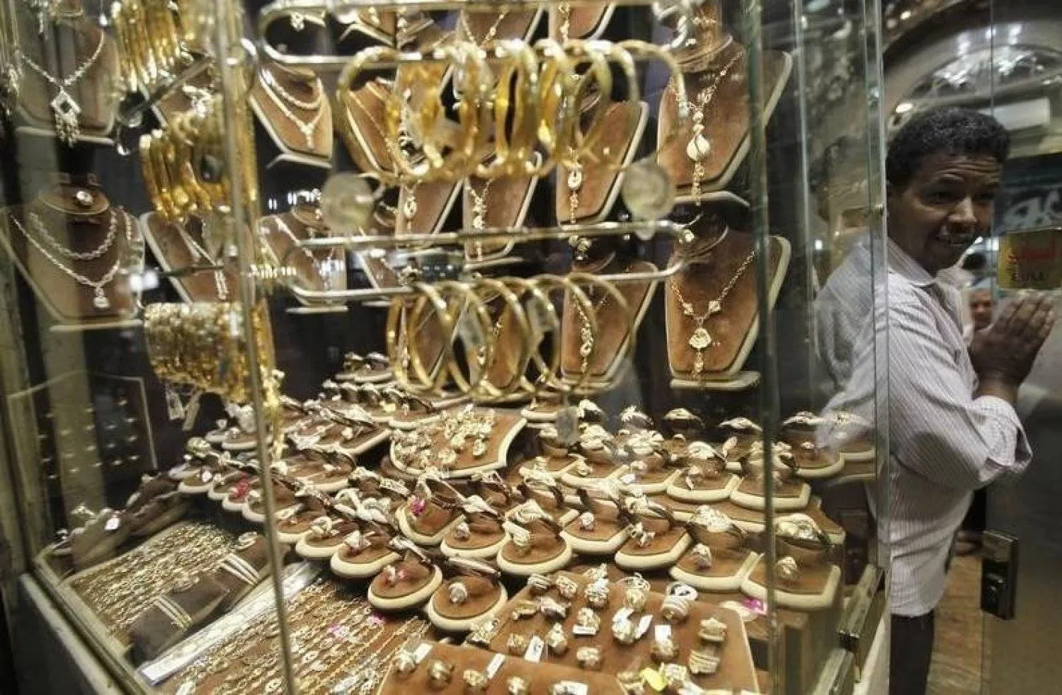 An employee at a gold shop in Khan El Khalili, Cairo (Reuters)