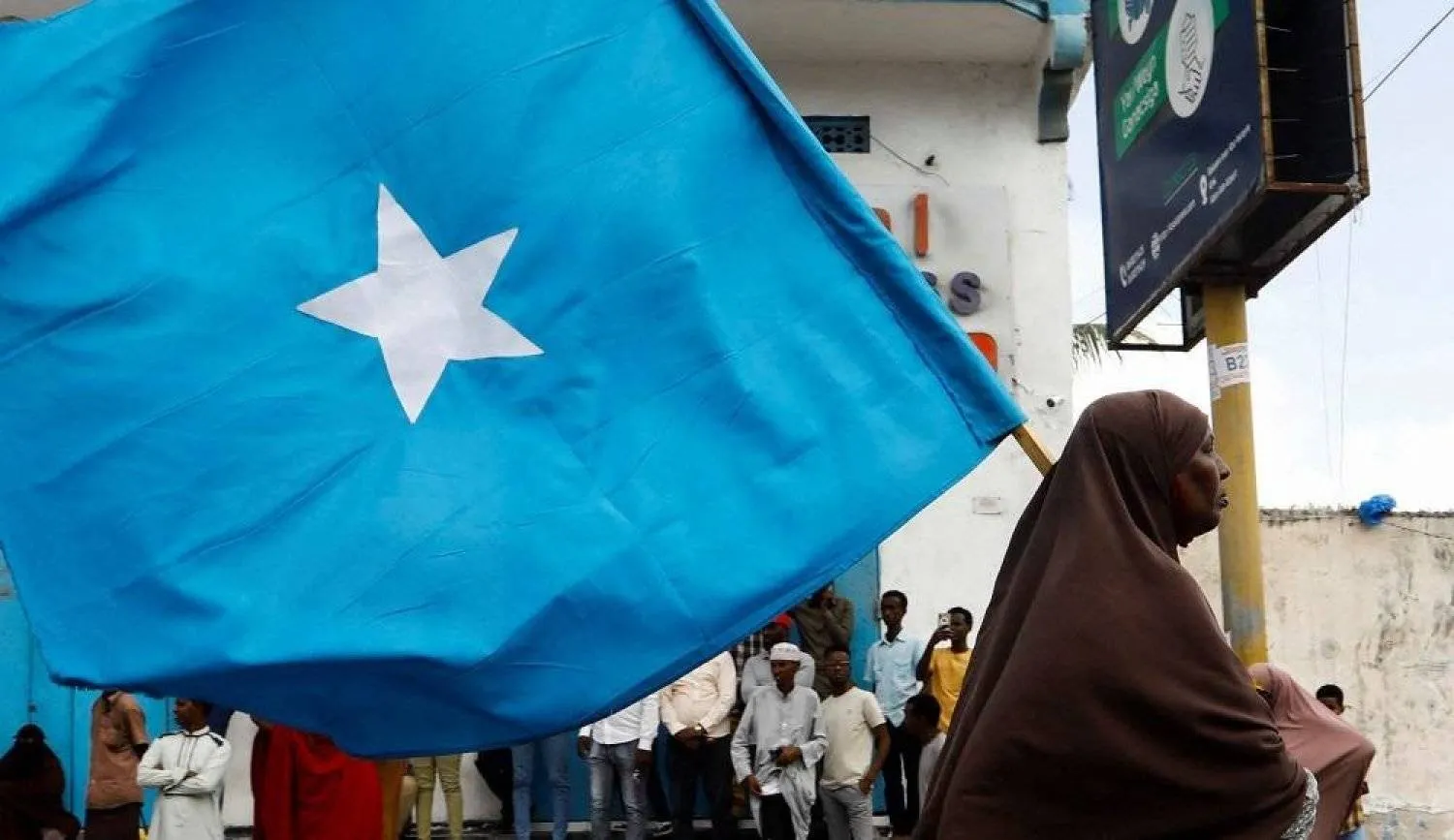 A Somali woman carries their flag during a march against the Ethiopia-Somaliland port deal along KM4 street in Mogadishu, Somalia January 11, 2024. (Reuters)

