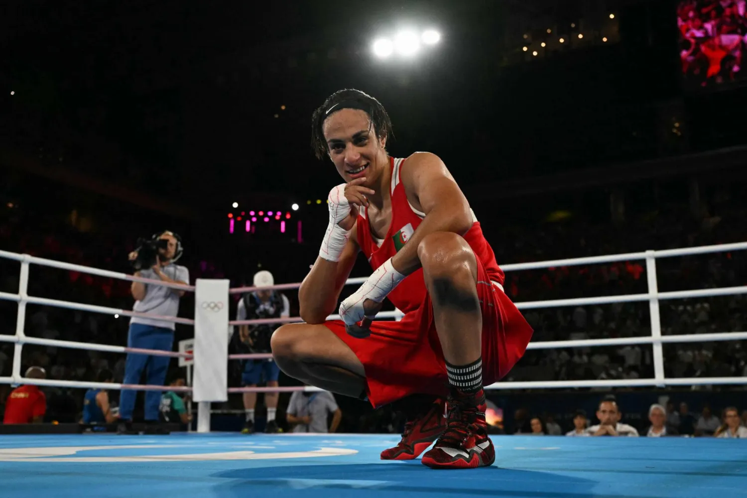 Algeria's Imane Khelif reacts after beating China's Yang Liu (Blue) in the women's 66kg final boxing match during the Paris 2024 Olympic Games at the Roland-Garros Stadium, in Paris on August 9, 2024. (Photo by MOHD RASFAN / AFP)