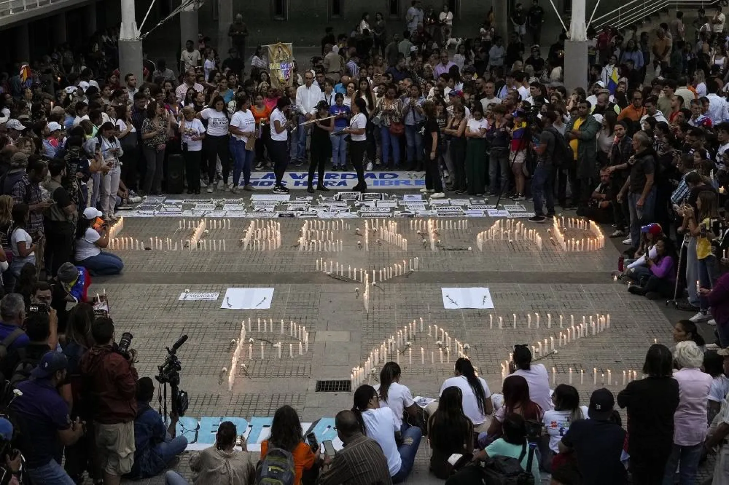 Family members of those detained amid a government crackdown on protestors participate in a vigil in Caracas, Venezuela, Thursday, Aug. 8, 2024. The candles read in Spanish: "Freedom and peace." (AP)