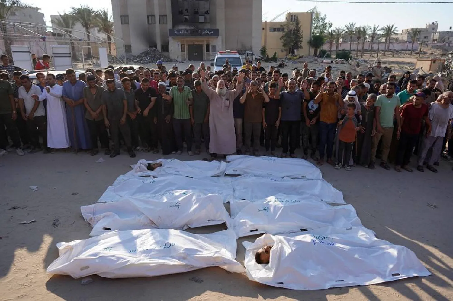  Palestinians recite a prayer over the bodies of people killed in Israeli bombardment, at the Nasser hospital in Khan Younis in the southern Gaza Strip on August 14, 2024, amid the ongoing conflict between Israel and the Hamas group. (AFP) 