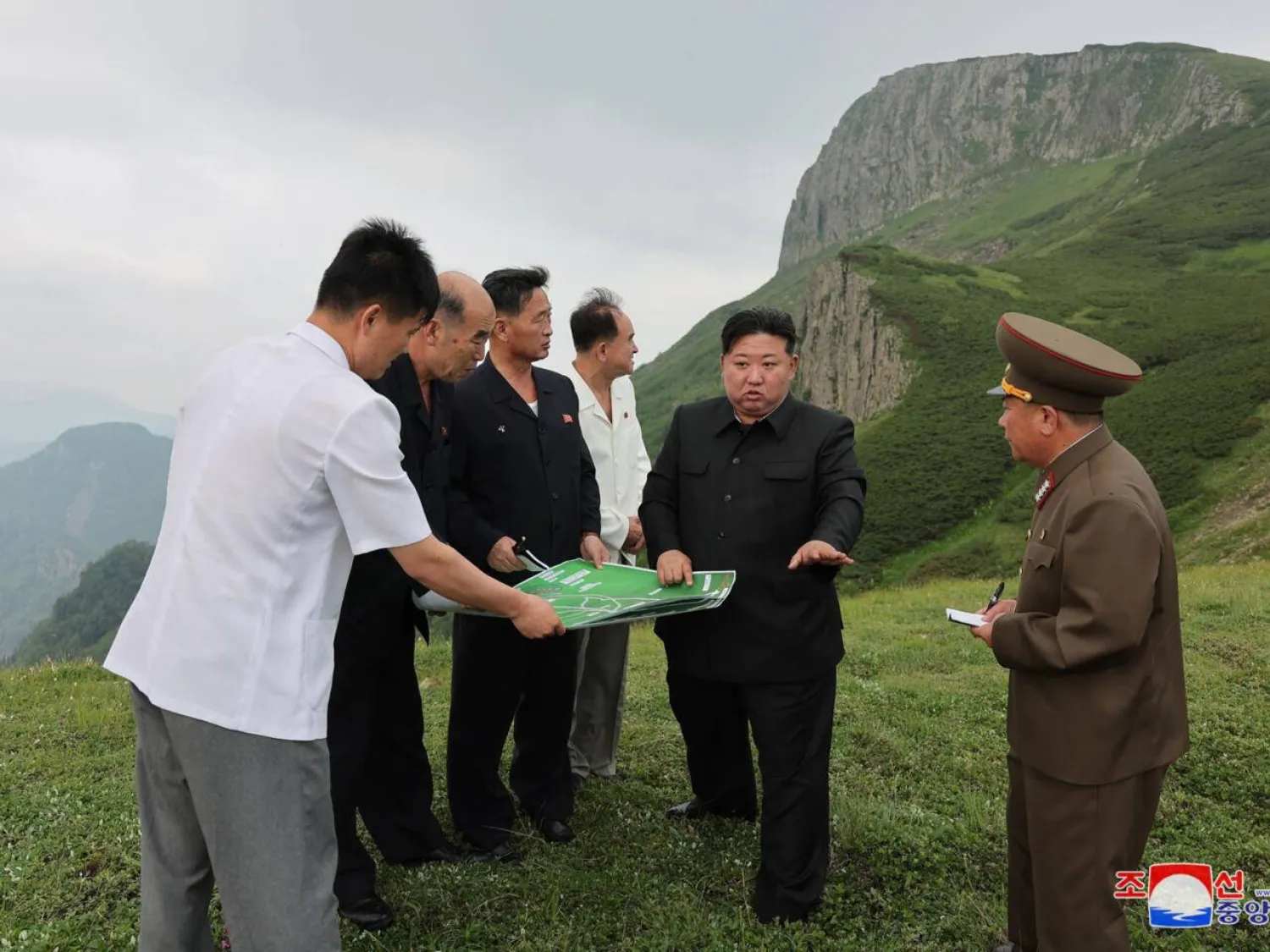Kim Jong Un (C) has poured huge resources into developing the Samjiyon area, with the vast project including new apartments, hotels and a ski resort. STR / KCNA VIA KNS/AFP
