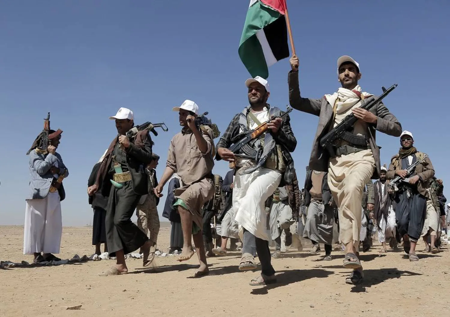 Houthi fighters march during a rally of support for the Palestinians in the Gaza Strip and against the US strikes on Yemen outside Sanaa on Jan. 22, 2024. (AP) 