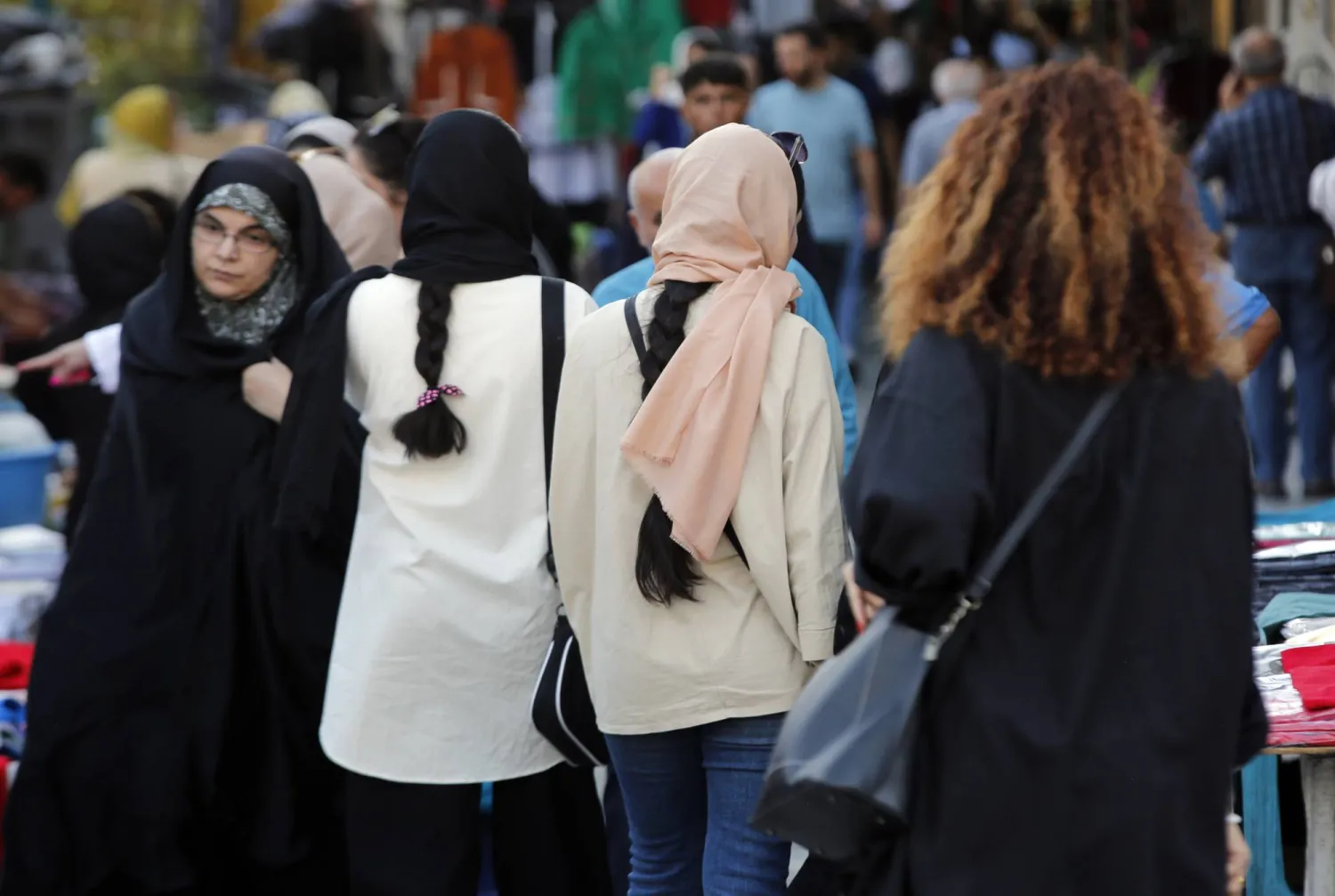 Iranian women, some without the mandatory headscarf, walk in a street in Tehran, Iran, 13 September 2023. EPA/ABEDIN TAHERKENAREH