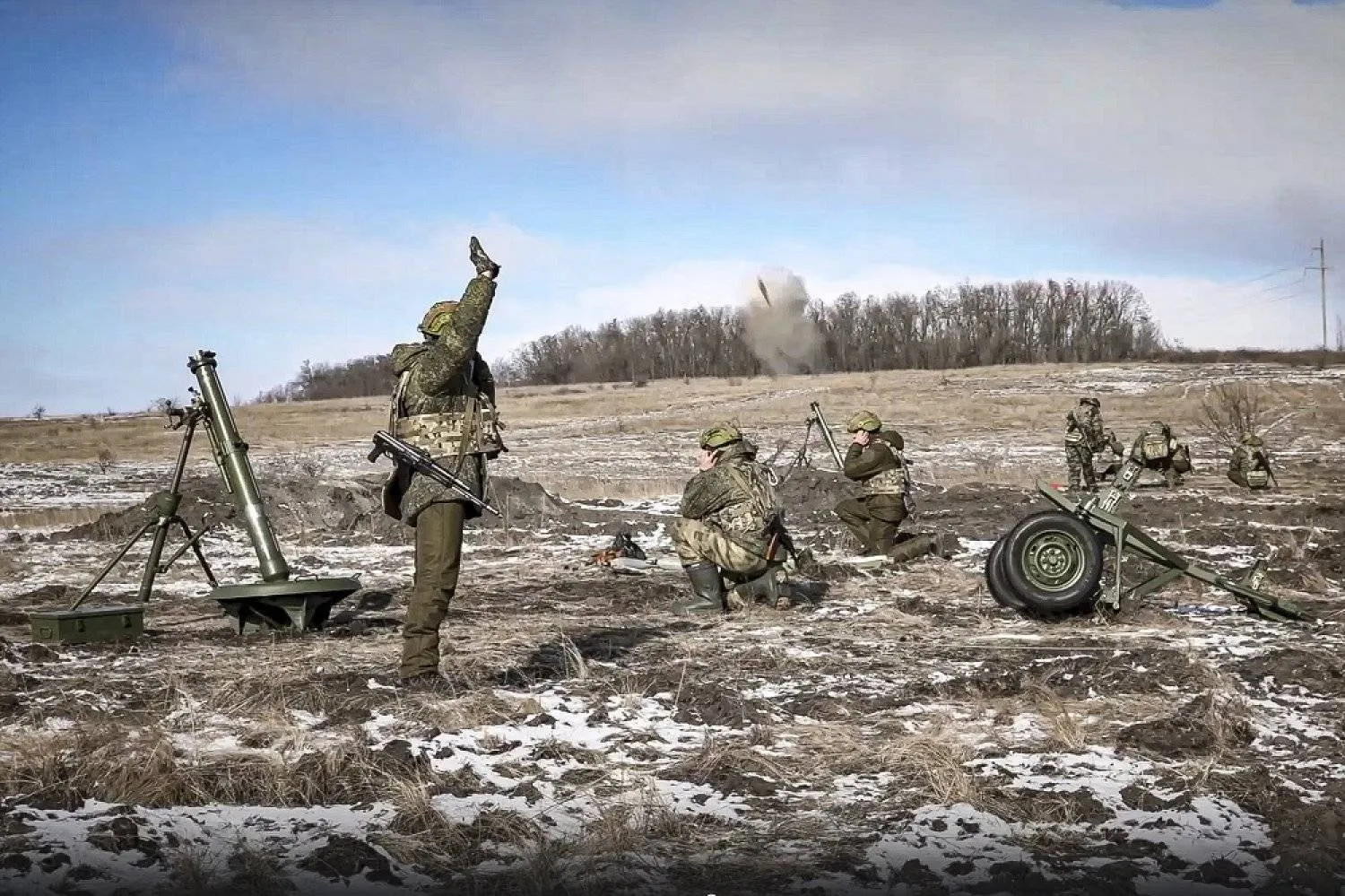 In this handout photo taken from video and released by Russian Defense Ministry Press Service on Friday, Feb. 17, 2023, the Russian army's 120 mm mortars fire at Ukrainian troops at an undisclosed location. (Russian Defense Ministry Press Service via AP)