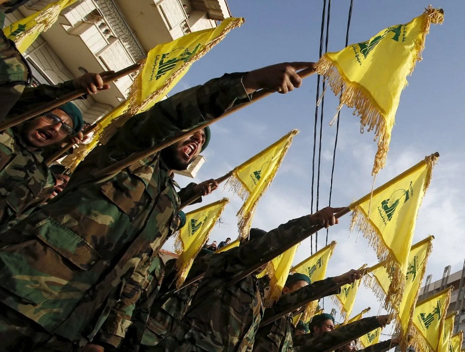 Hezbollah members carry flags during the funeral of a fellow fighter. (Reuters)
