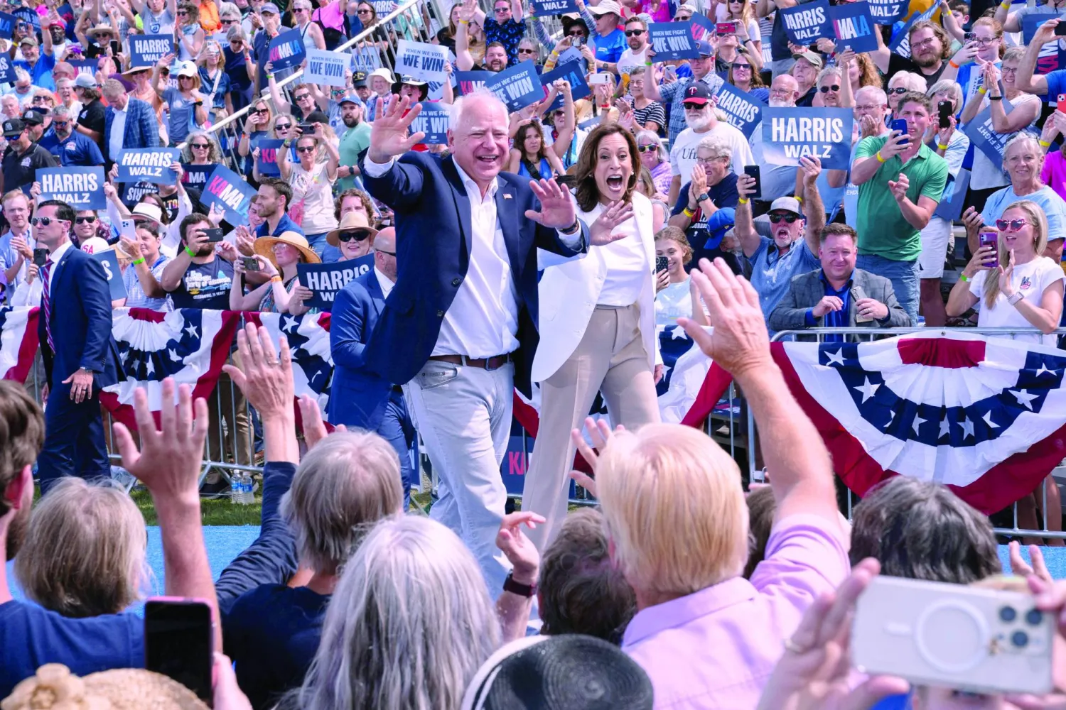 FILE PHOTO: US Vice President and Democratic presidential candidate Kamala Harris and her running mate Minnesota Governor Tim Walz greet the crowd during a campaign event in Eau Claire, Wisconsin, US, August 7, 2024.  REUTERS/Erica Dischino/File Photo/File Photo