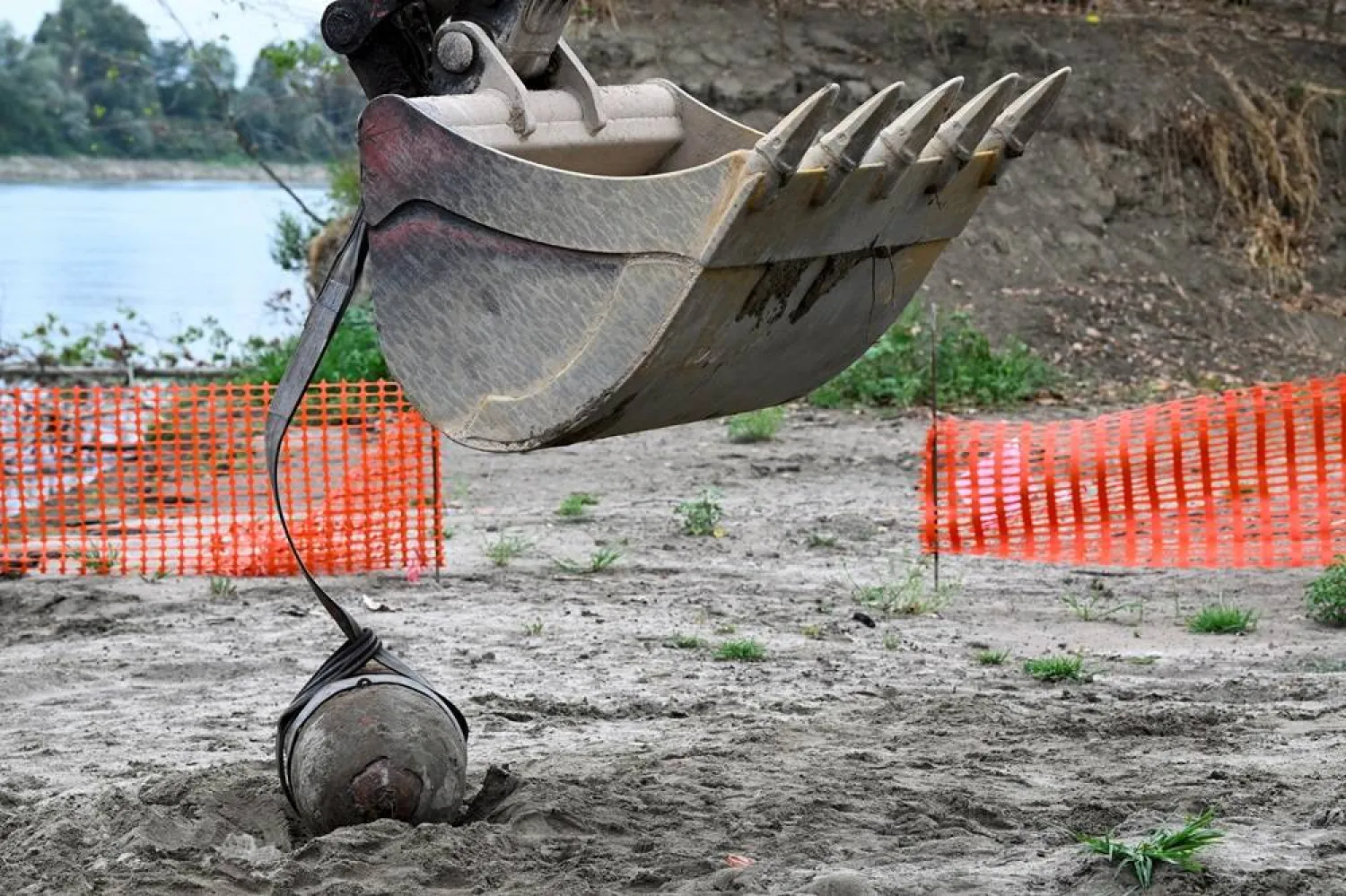 A World War Two bomb is seen being removed a few days after being discovered in the dried-up river Po which suffered from the worst drought in 70 years, in Borgo Virgilio, Italy on August 7, 2022. (Reuters)