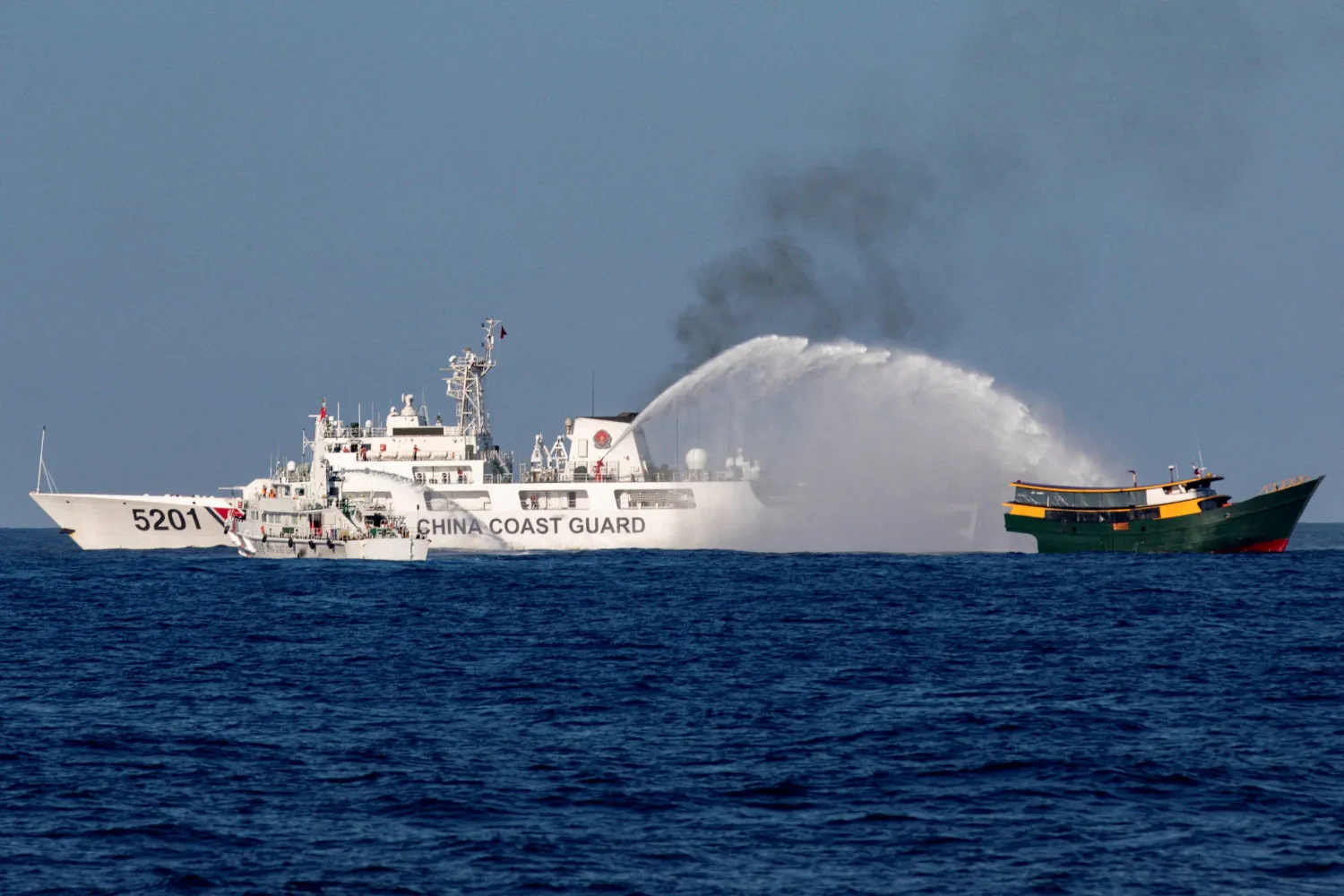 FILE PHOTO: Chinese Coast Guard vessels fire water cannons towards a Philippine resupply vessel Unaizah May 4 on its way to a resupply mission at Second Thomas Shoal in the South China Sea, March 5, 2024. REUTERS/Adrian Portugal