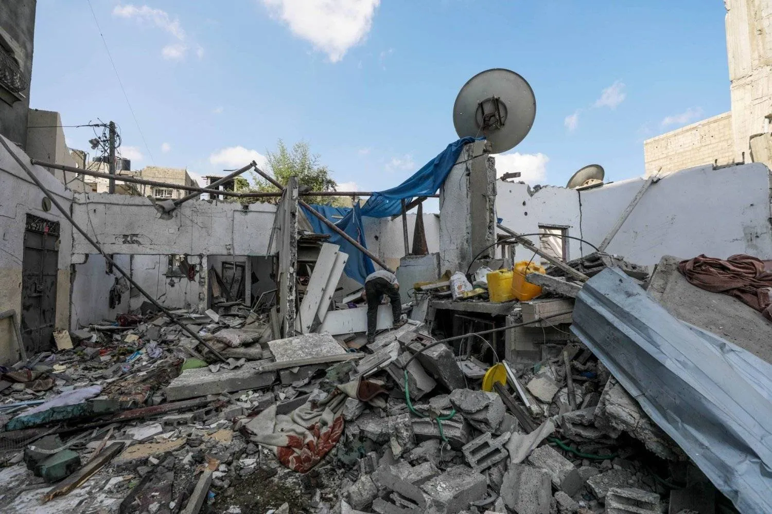 A Palestinian inspects the damage of a destroyed house following an Israeli air strike in the Al-Maghazi refugee camp in the Gaza Strip (EPA)
