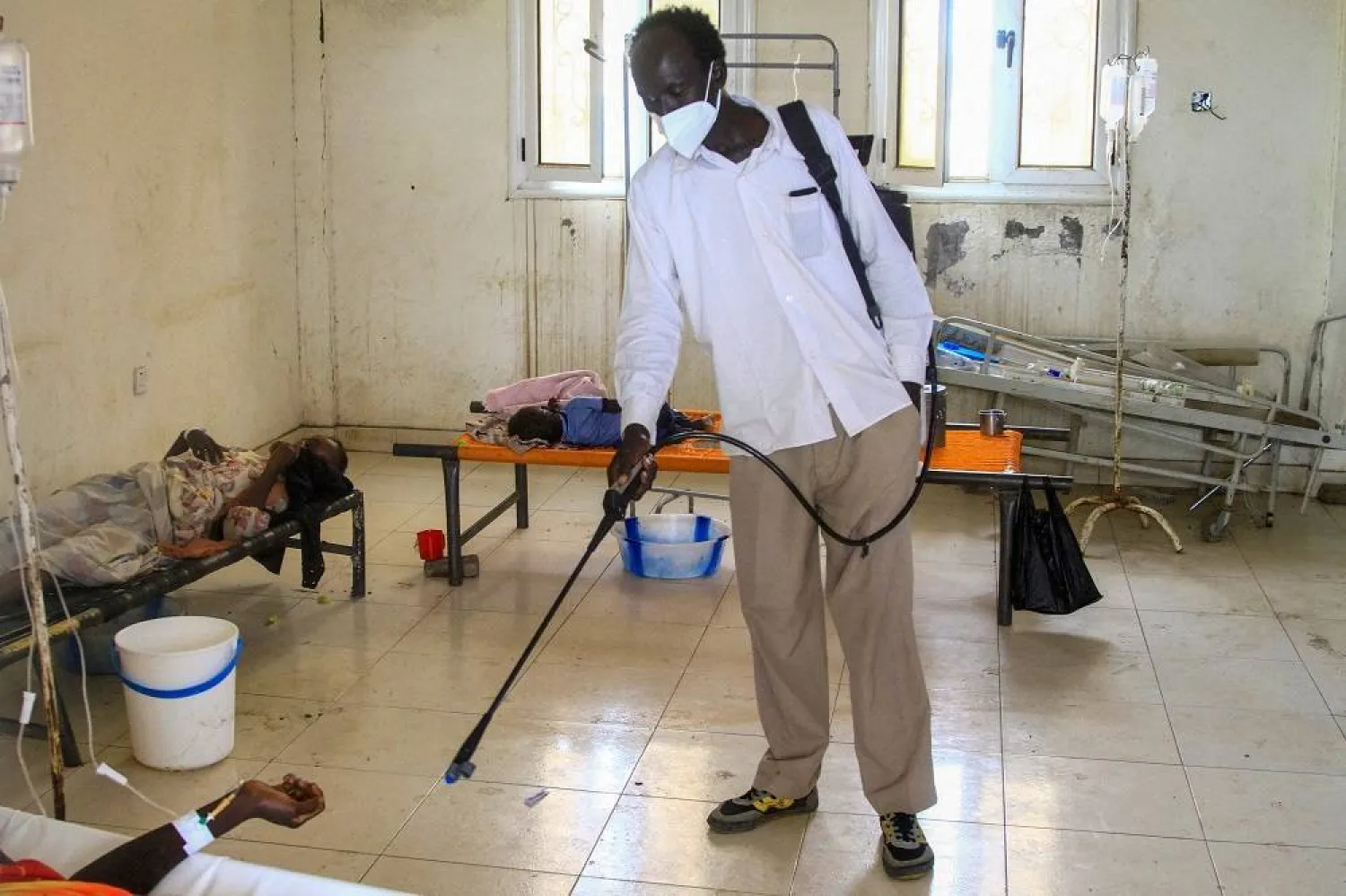 A man disinfects a rural isolation center where patients are being treated for cholera in Wad Al-Hilu in Kassala state in eastern Sudan, on August 17, 2024. (AFP)