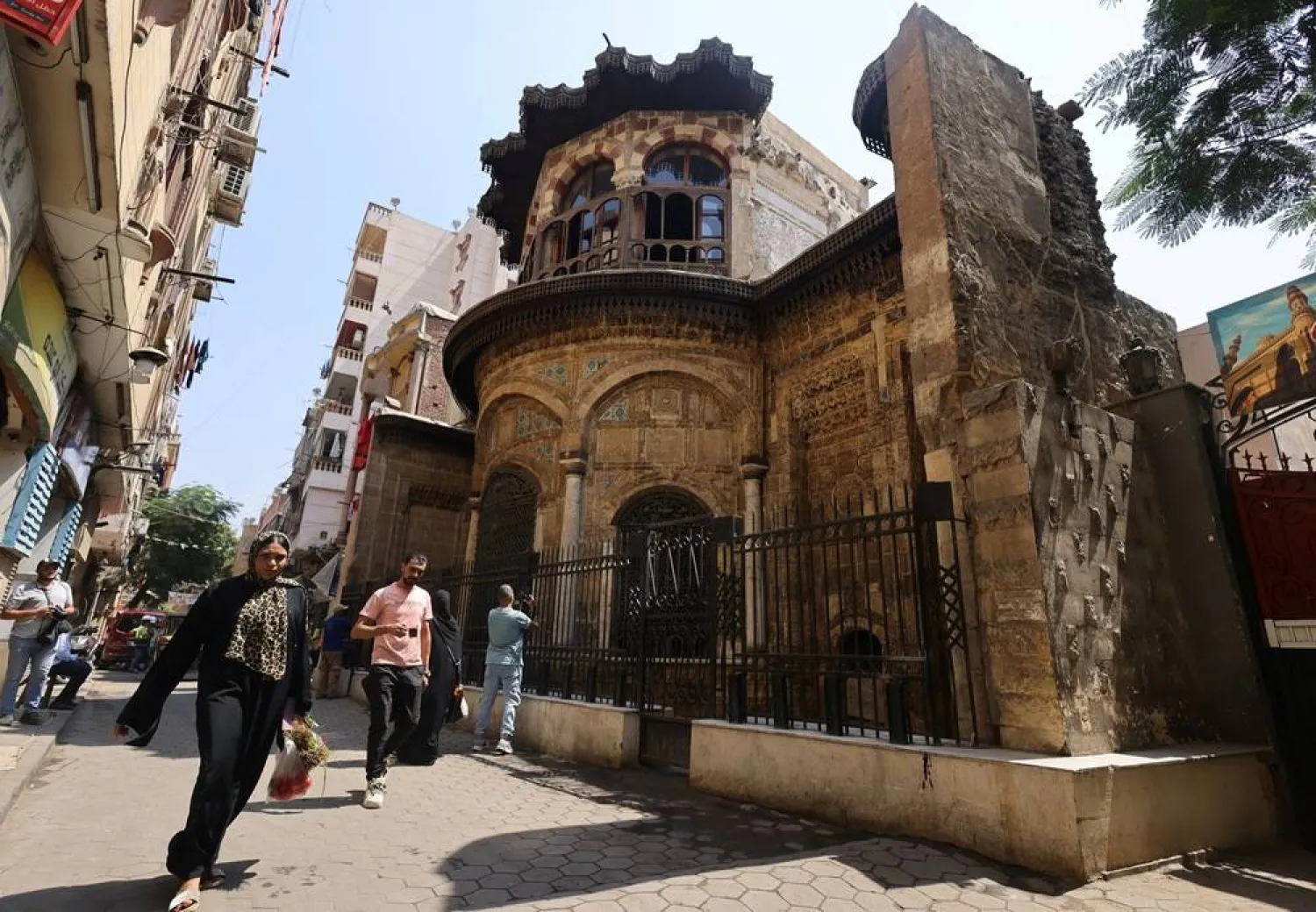 People walk in front of the "Sabil-Kuttab of Ruqayya Dudu" following extensive renovations carried out in partnership between Egypt's Tourism and Antiquities Ministry and the United States Agency for International Development (USAID), ensuring sustainable management of historic sites at Souk al-Silah district in Old Cairo, Egypt August 18, 2024. (Reuters)