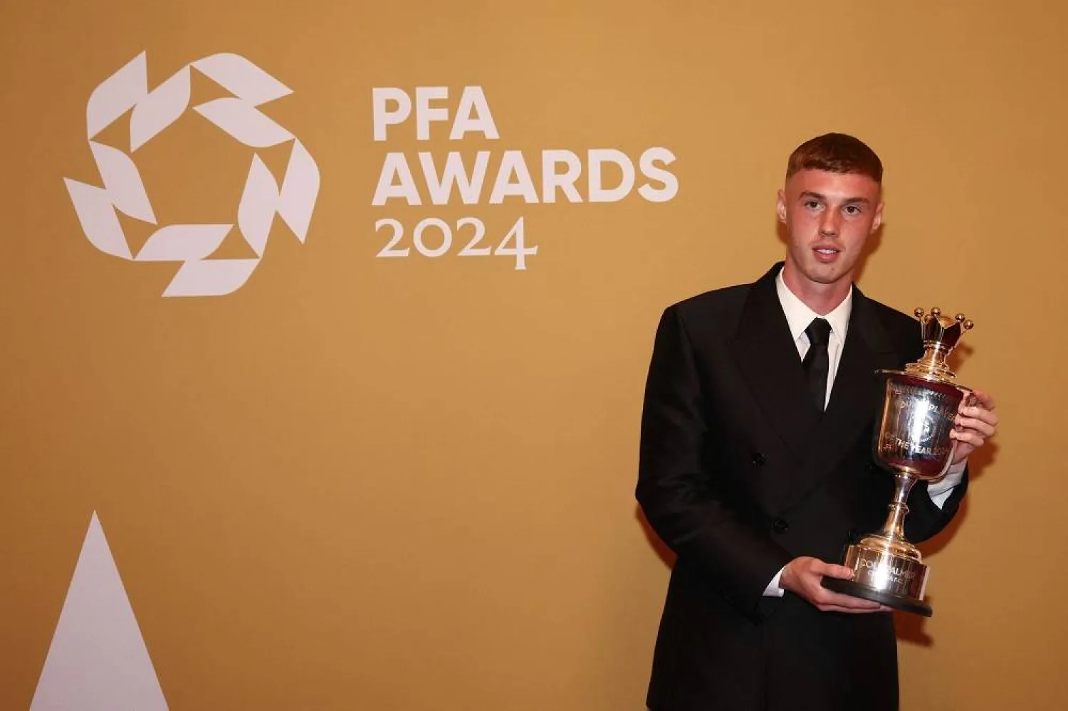 Chelsea's English midfielder Cole Palmer poses with the Men's PFA Young Player of the Year in the winners backstage during the 2023-2024 Professional Footballers' Association (PFA) awards, at the Opera House, in Manchester, northern England, on August 20, 2024. (AFP)