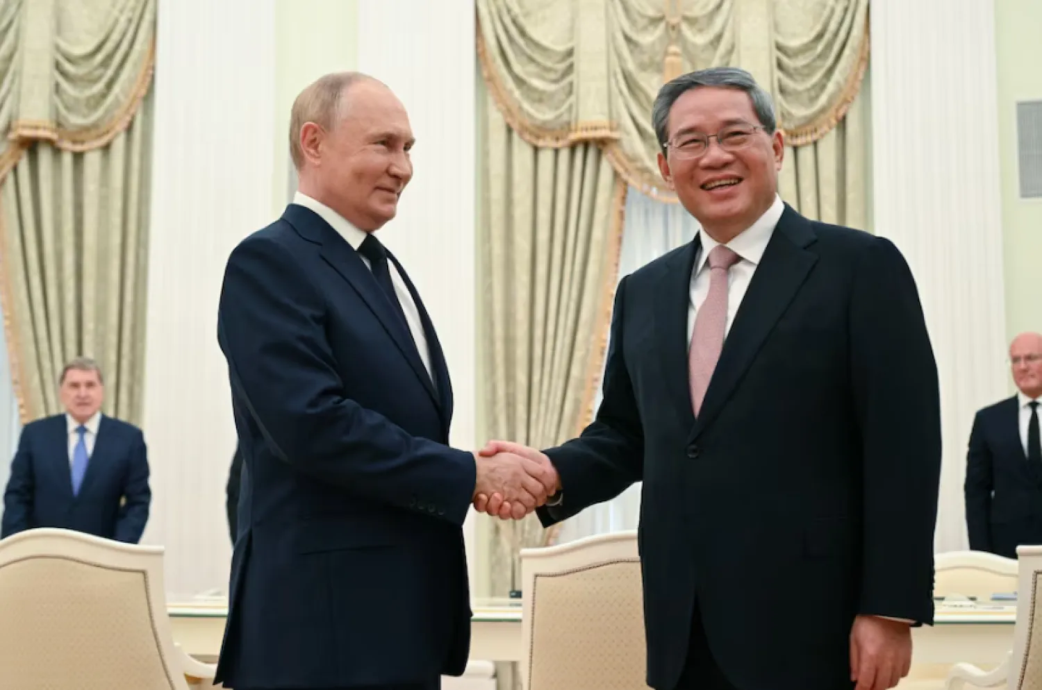 Russia's President Vladimir Putin and China's Premier Li Qiang shake hands during a meeting in Moscow, Russia August 21, 2024. Sputnik/Alexei Filippov/Pool via REUTERS Purchase Licensing Rights