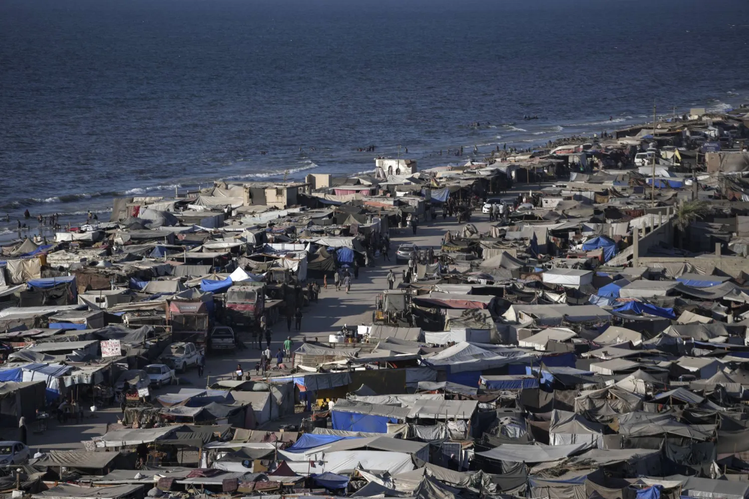 Tents are crammed together as displaced Palestinians camp on the beach, west of Deir al-Balah, Gaza Strip, Tuesday, Aug. 20, 2024. (AP Photo/Abdel Kareem Hana)