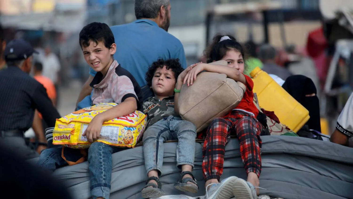 A Palestinian family flees Gaza's main southern city of Khan Yunis in response to an Israeli evacuation order. Bashar TALEB / AFP/File
